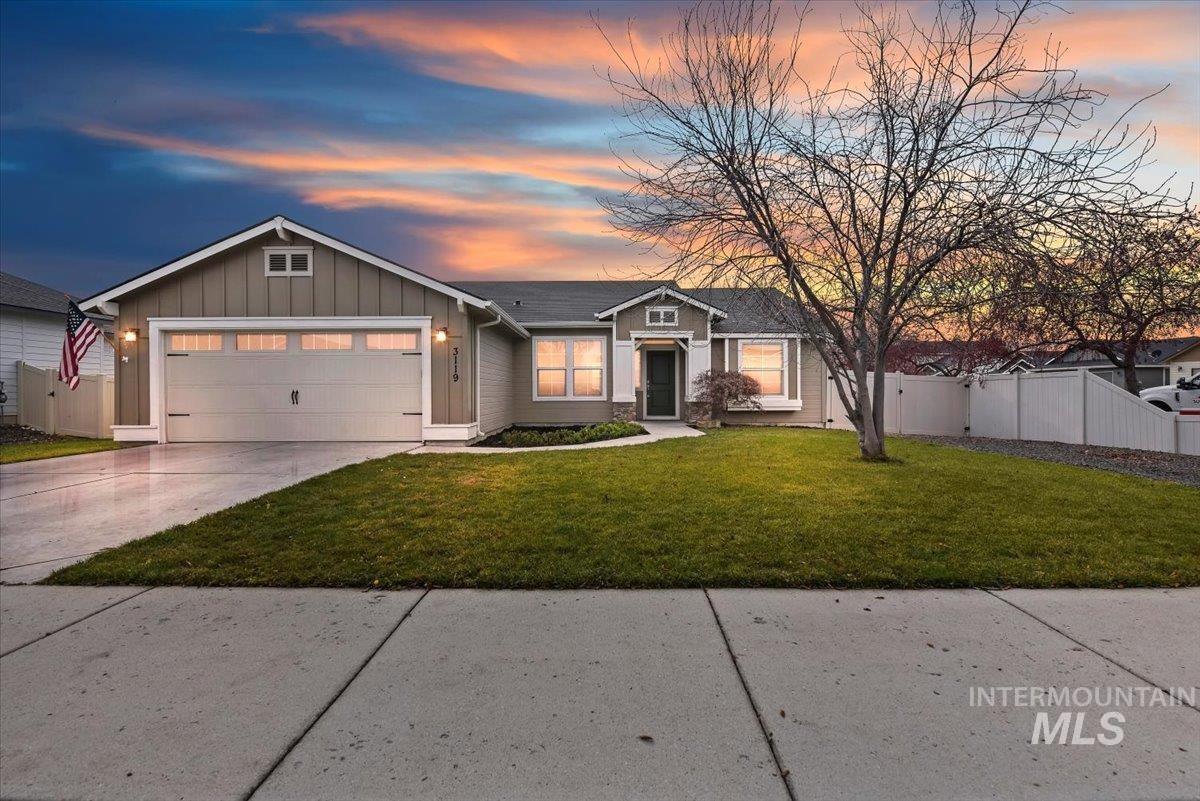 View of front of home featuring board and batten siding, a garage, and driveway
