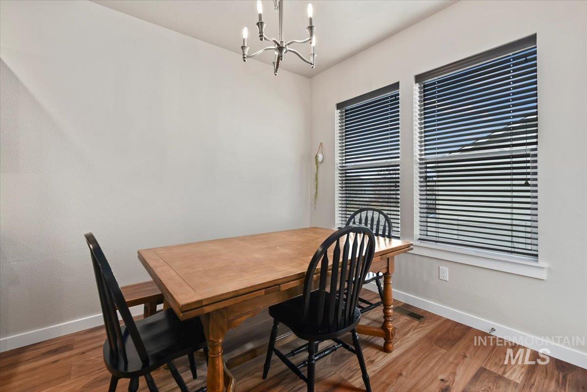 Dining area featuring wood finished floors and a chandelier