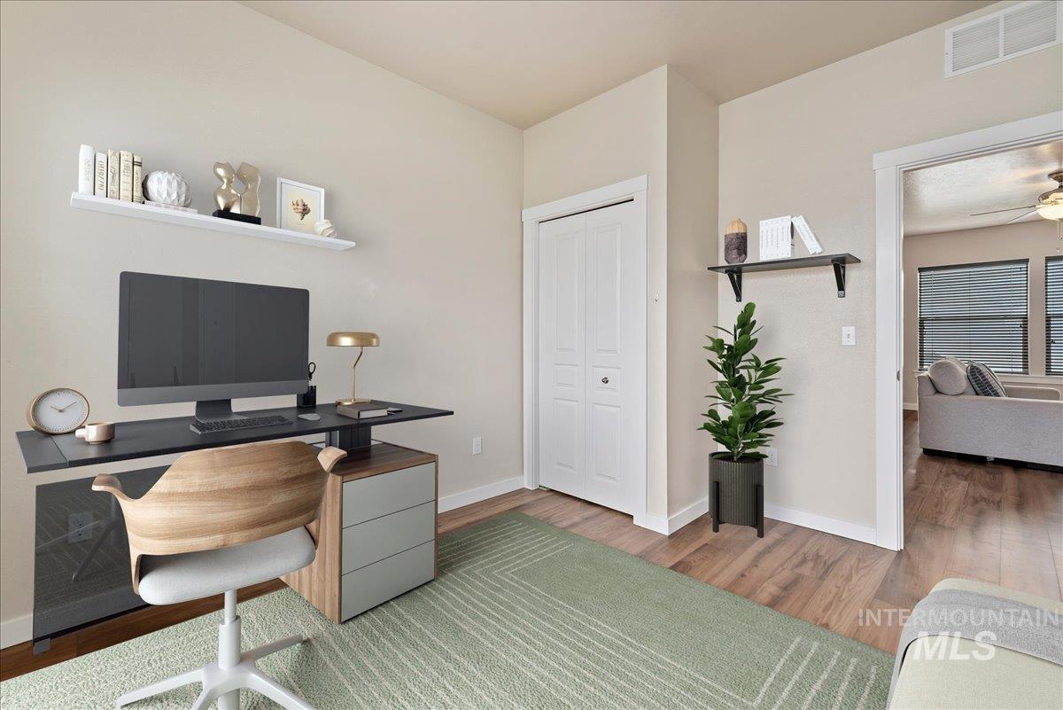 Bedroom 1 easily converts to office featuring wood finished floors