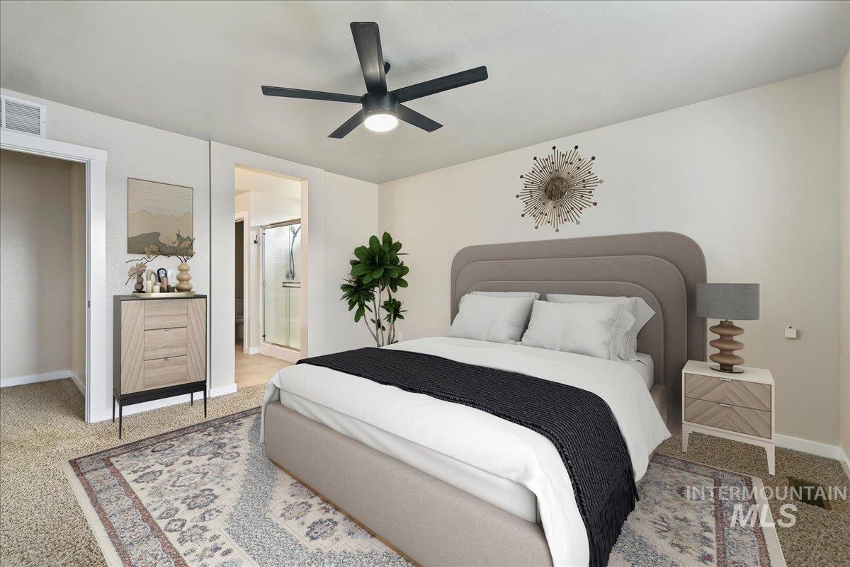 Bedroom featuring a ceiling fan, light colored carpet, and connected bathroom