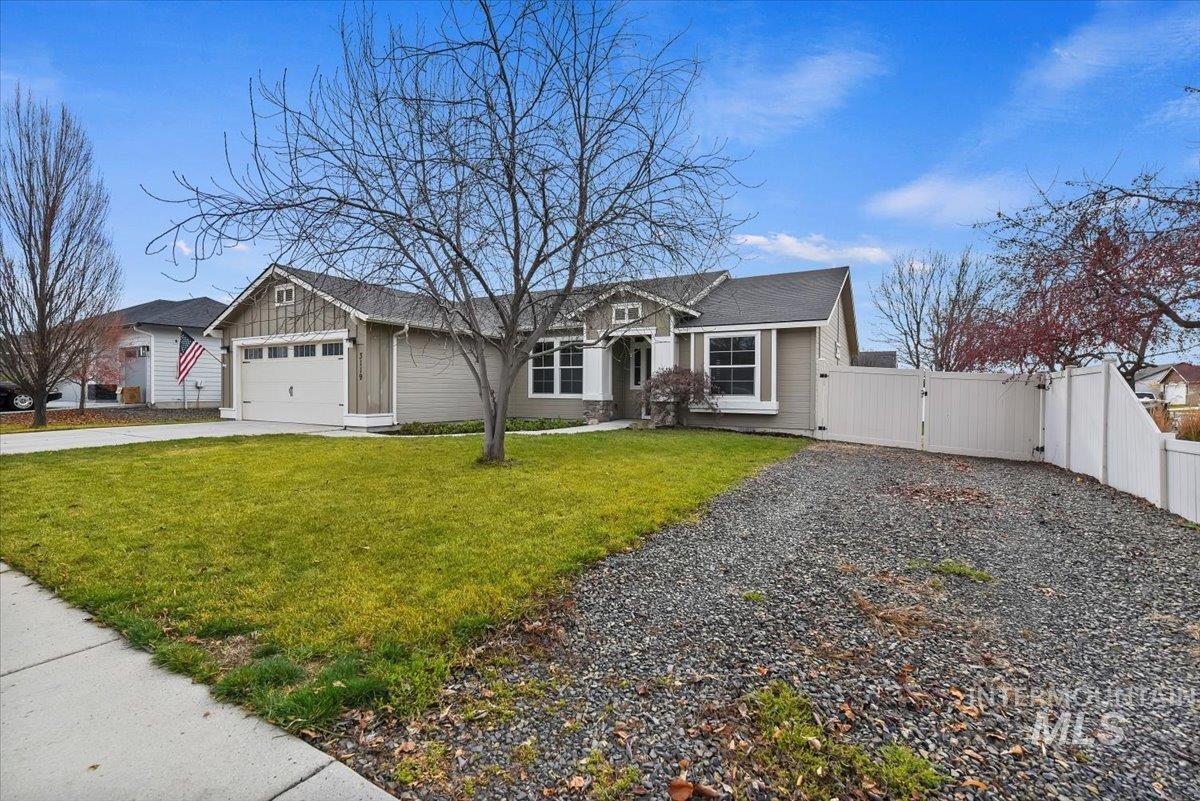View of front of home with driveway, a gate, board and batten siding, and a garage