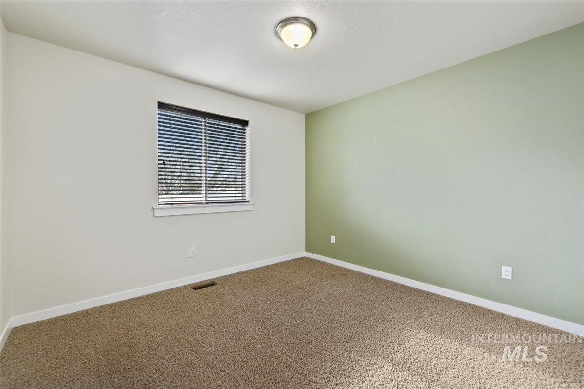 Carpeted bedroom 4 featuring baseboards