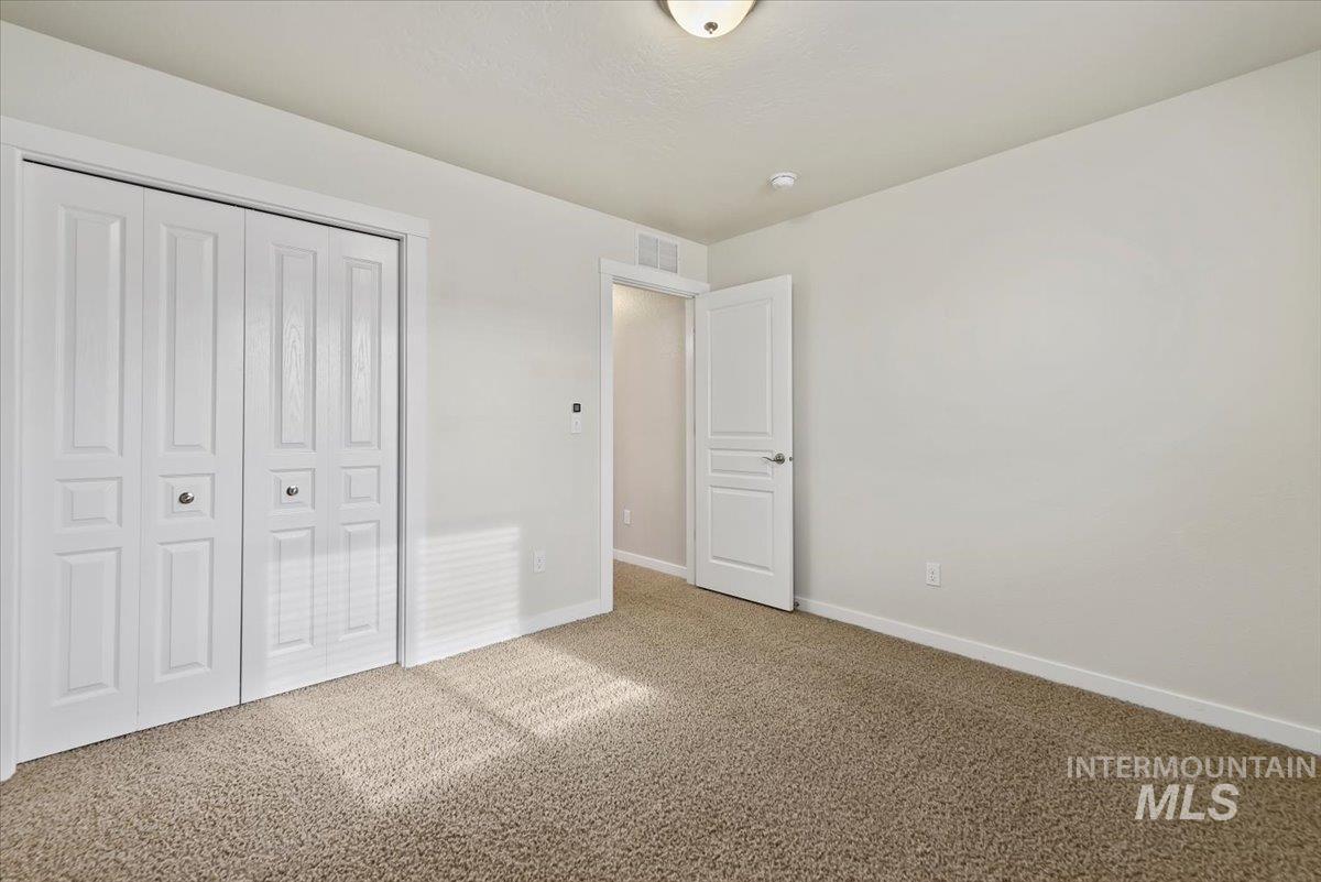 Unfurnished bedroom 4 featuring carpet floors and a closet