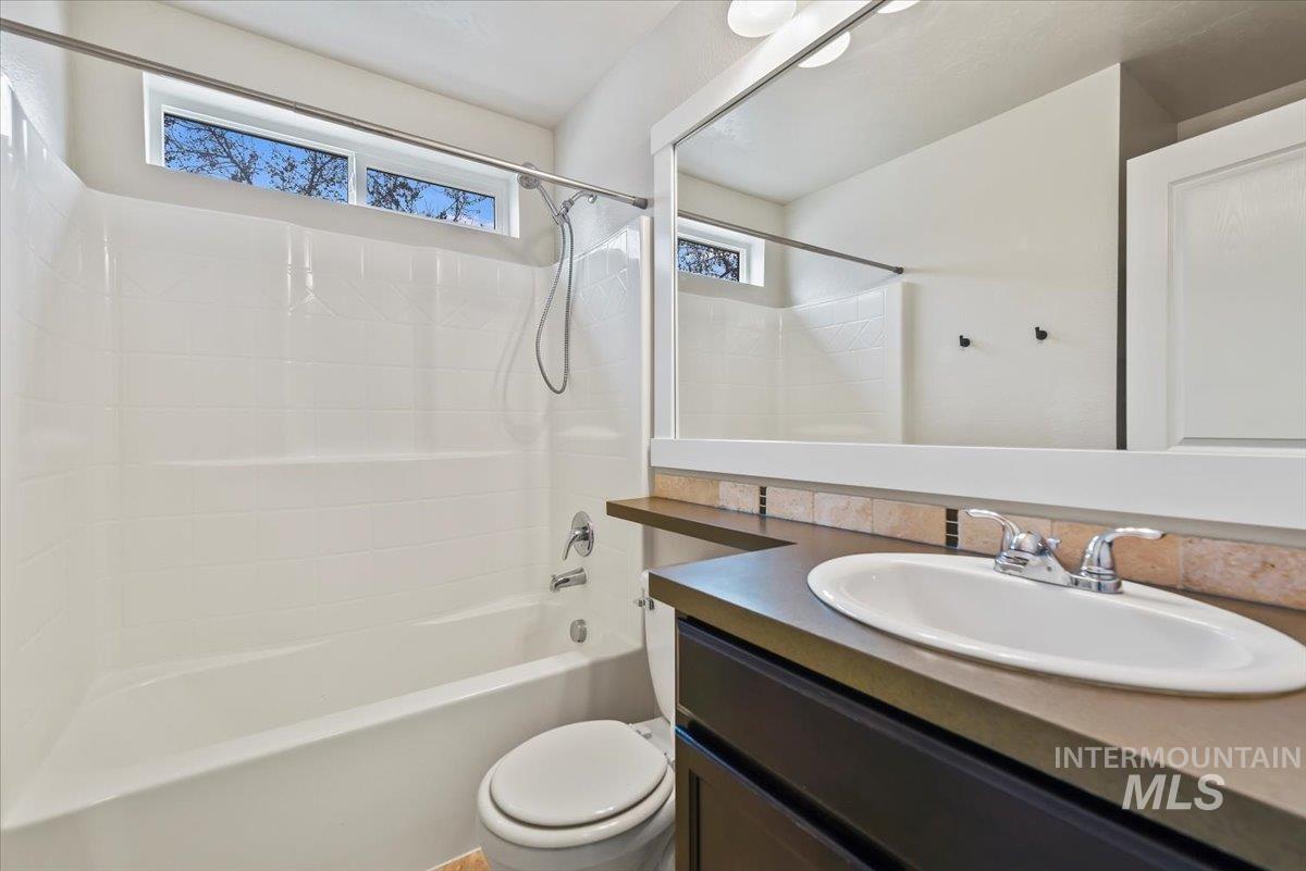 Full bathroom with shower / tub combination and vanity