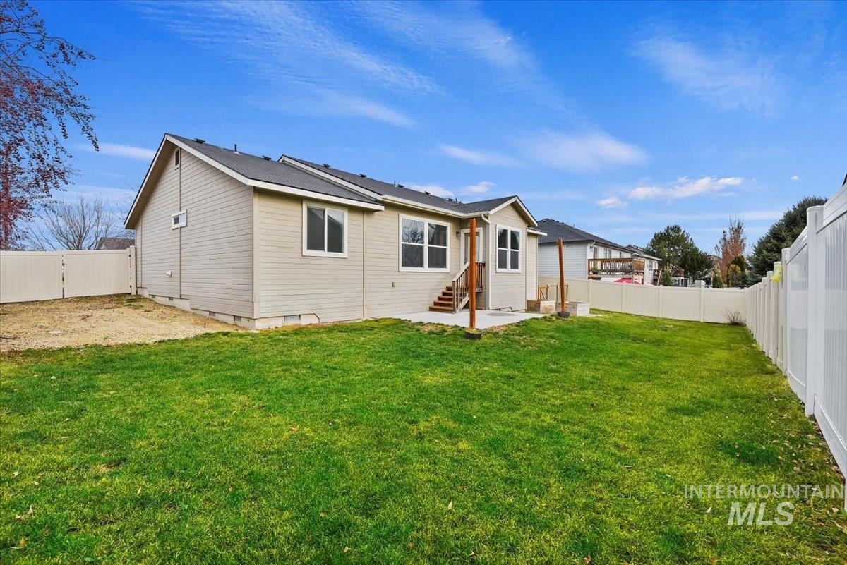 Rear view of house with crawl space, a fenced backyard, and a patio