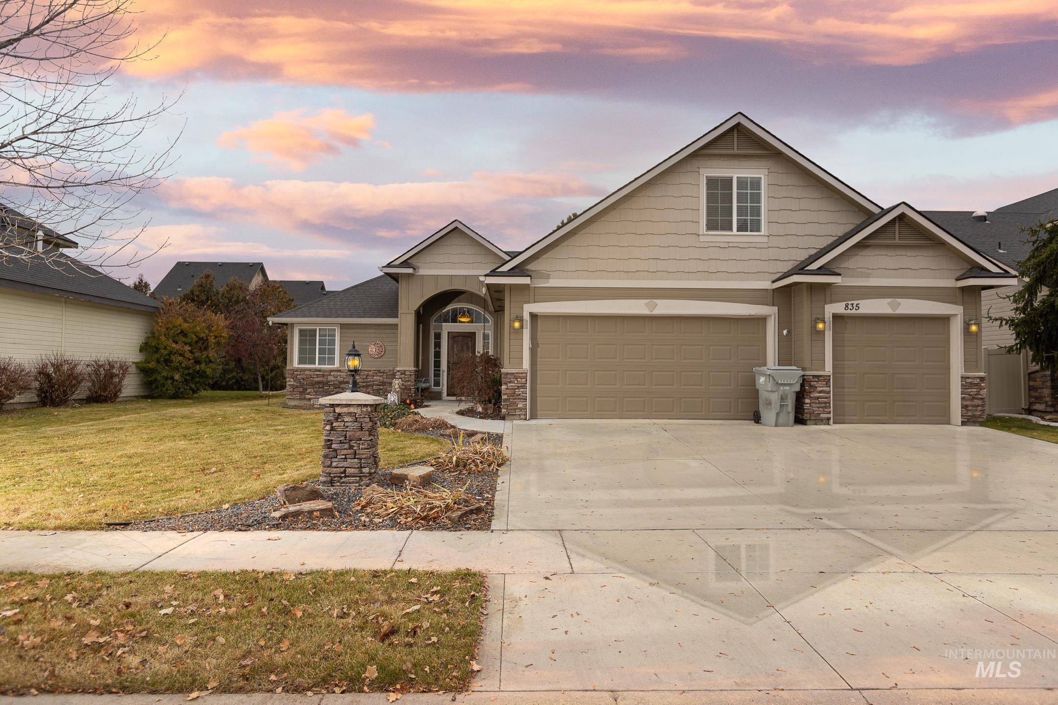 Craftsman house with stone siding, concrete driveway, and a front yard