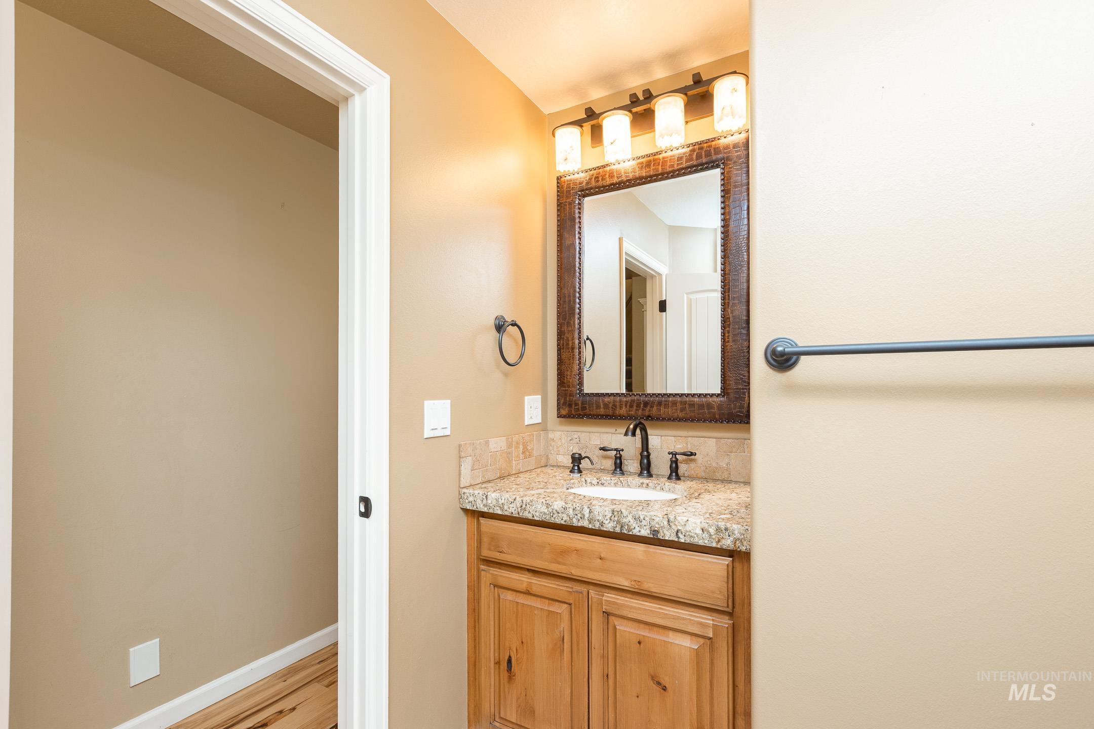 Bathroom featuring vanity and light wood finished floors