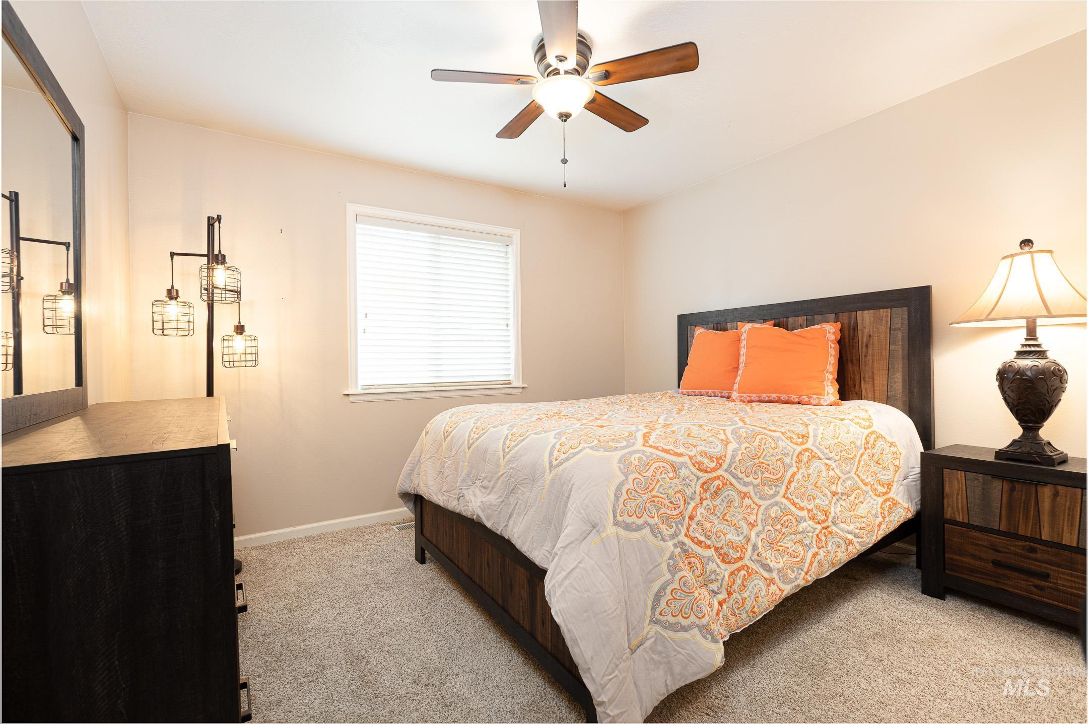Bedroom featuring light carpet and ceiling fan