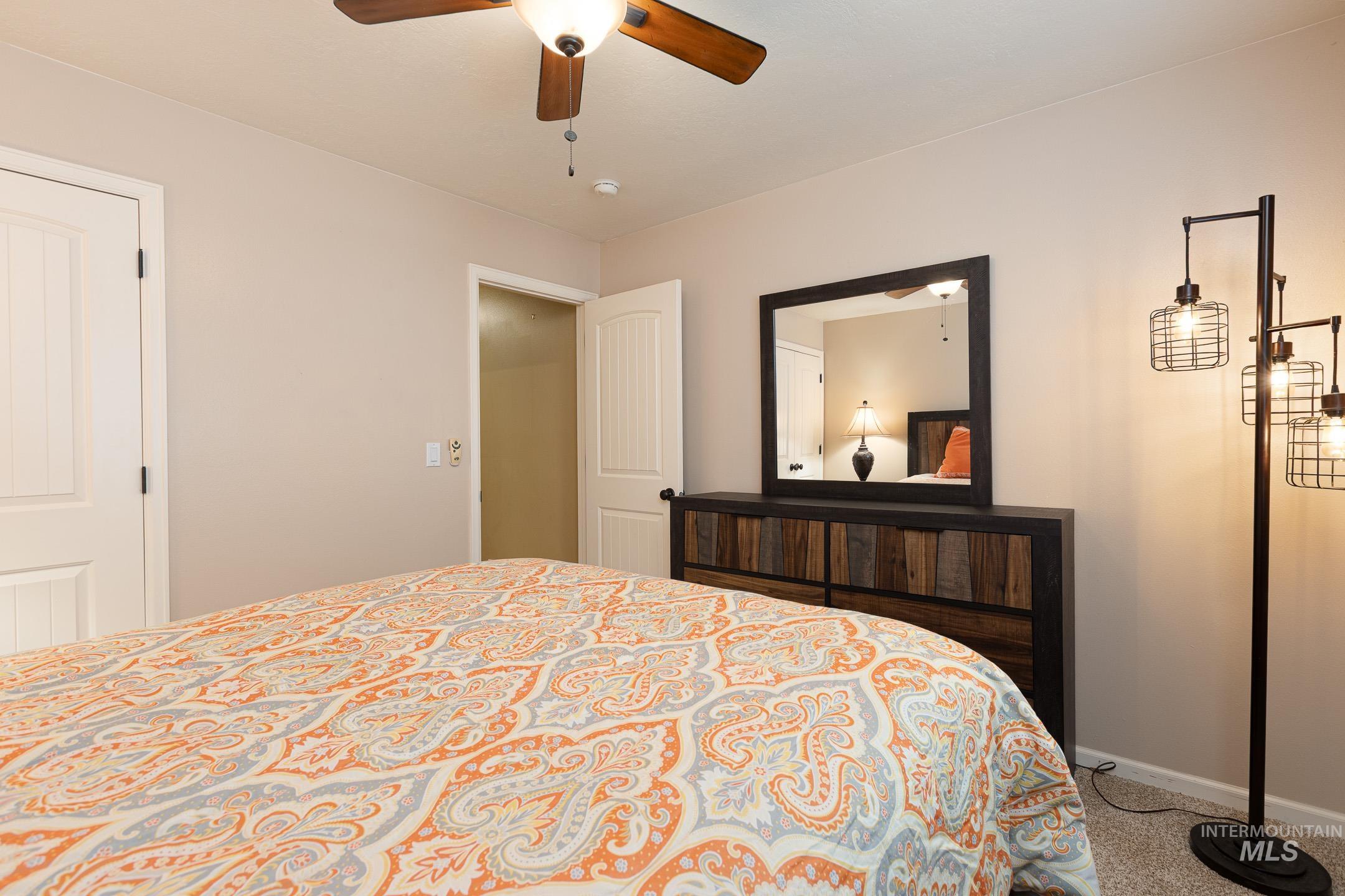 Bedroom with carpet and ceiling fan