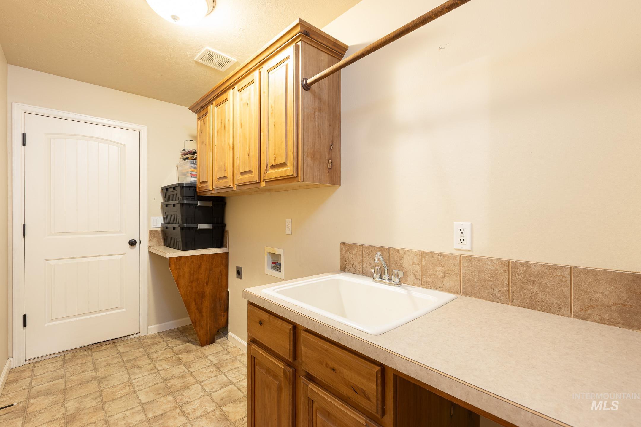 Laundry area with washer hookup, cabinet space, and hookup for an electric dryer