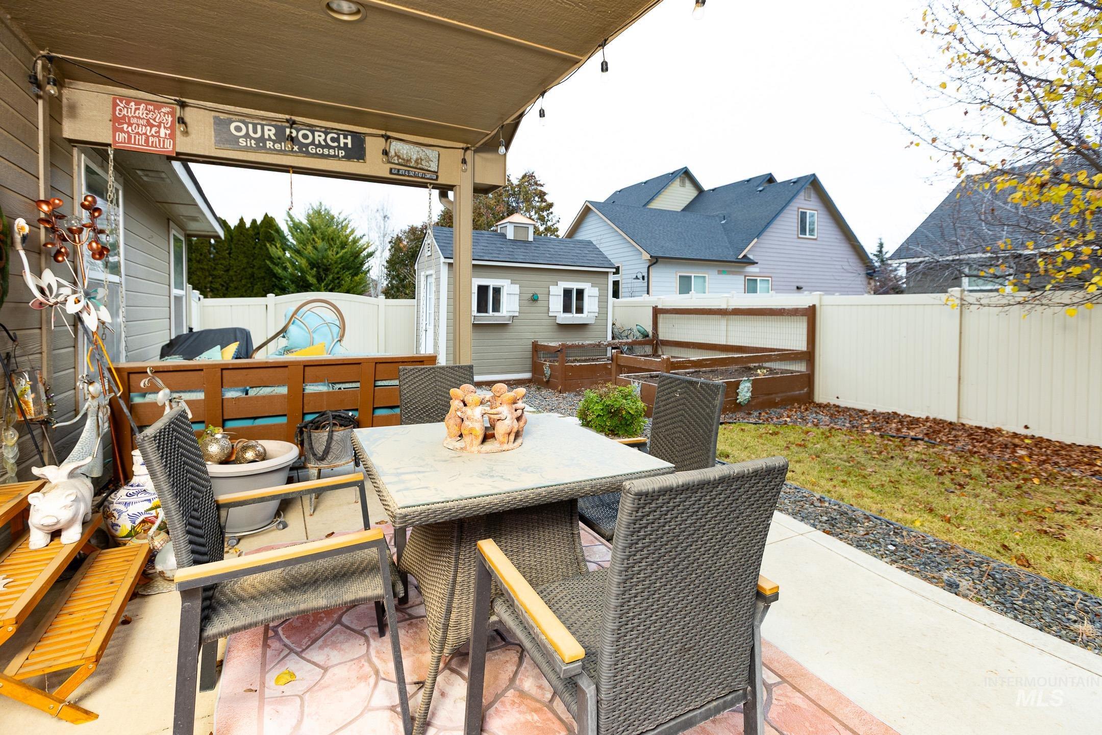 Fenced backyard with outdoor dining area, a patio area, and a deck