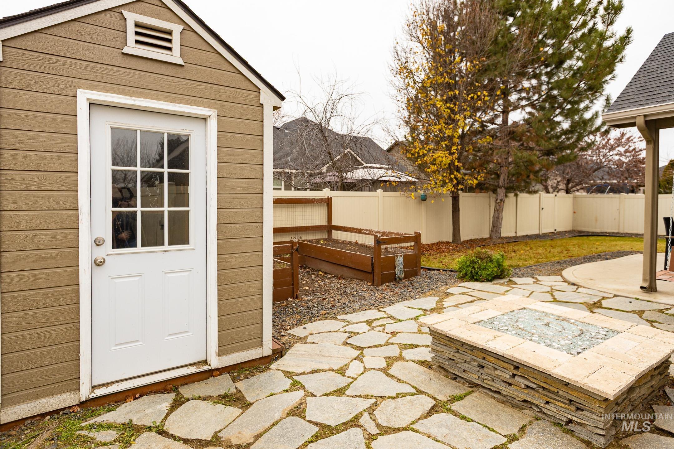 Fenced backyard with a garden and a patio