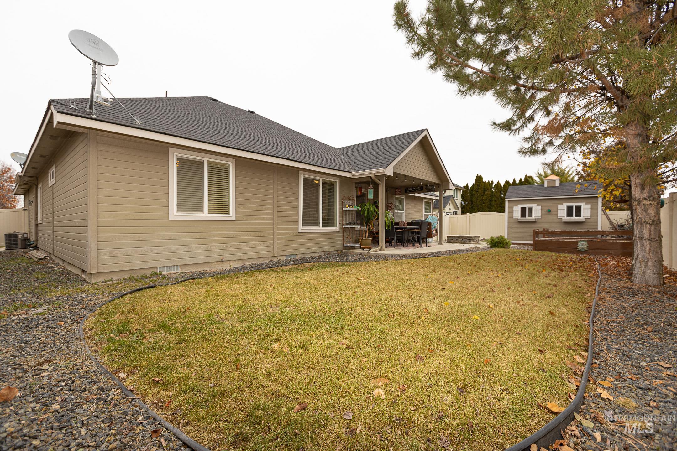 Back of house featuring a patio and a shingled roof