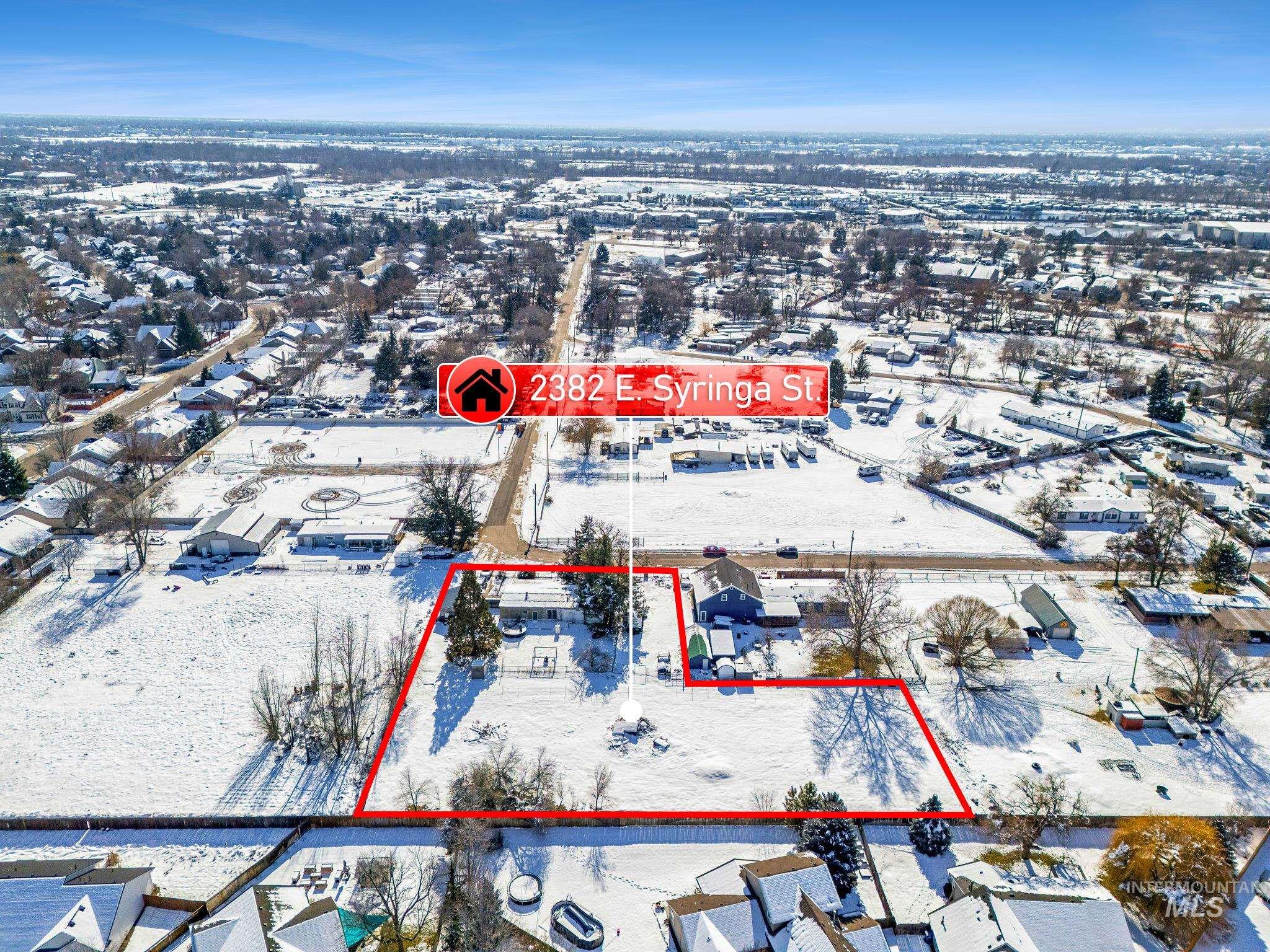 Snowy aerial view with property parcel outlined