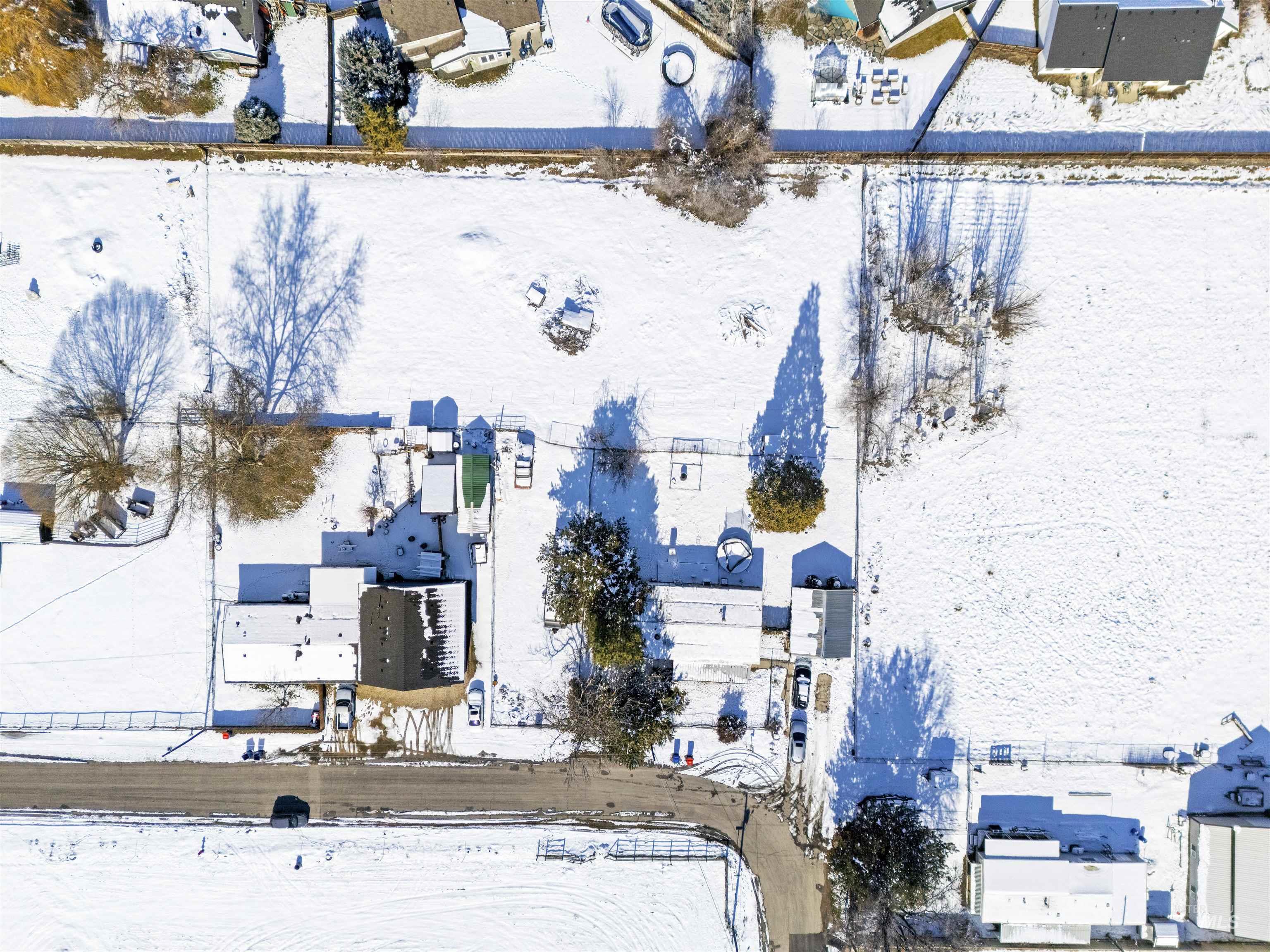 Snowy aerial view featuring a residential view