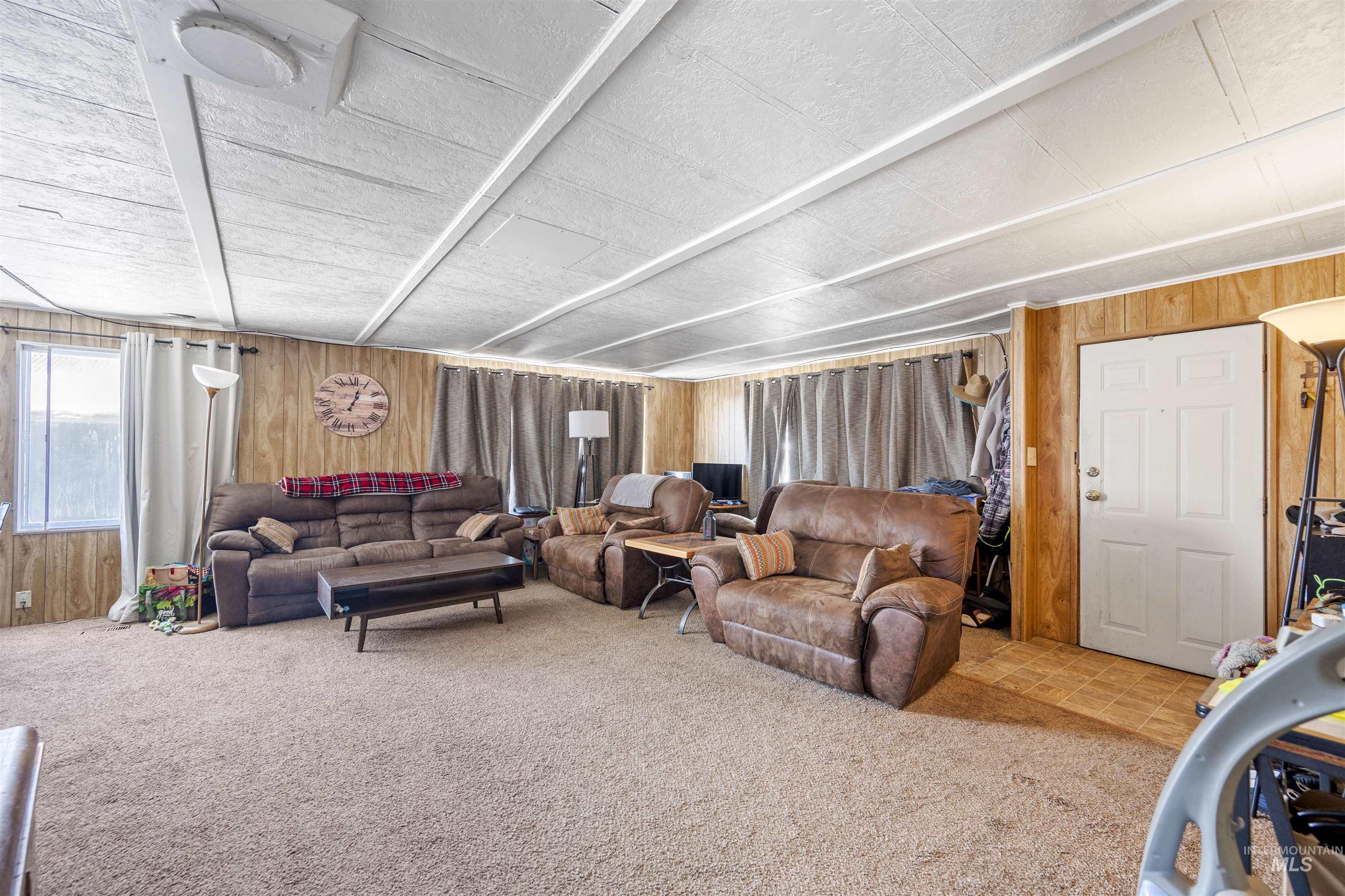 Living area with wood walls and carpet floors