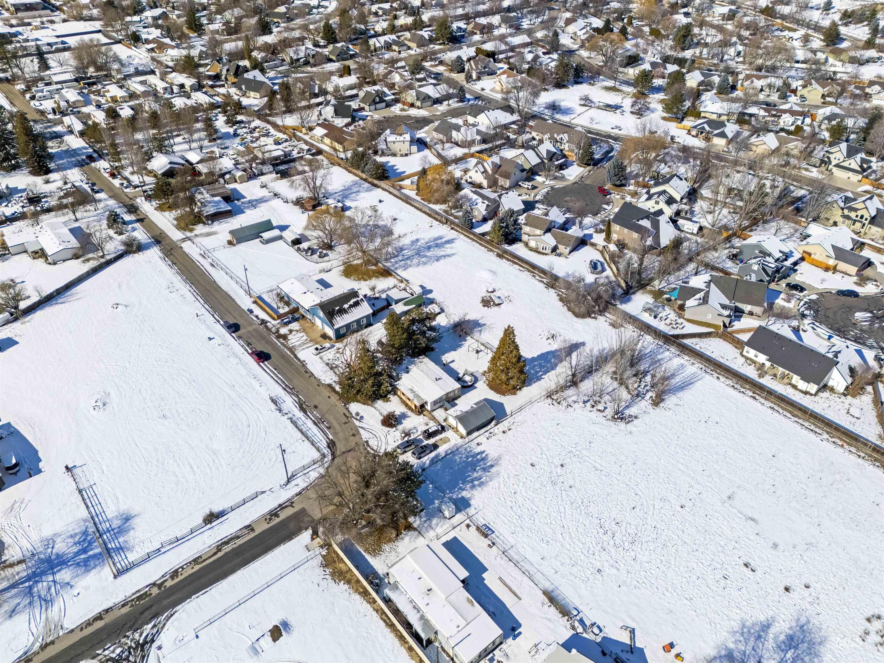 Snowy aerial view featuring a residential view