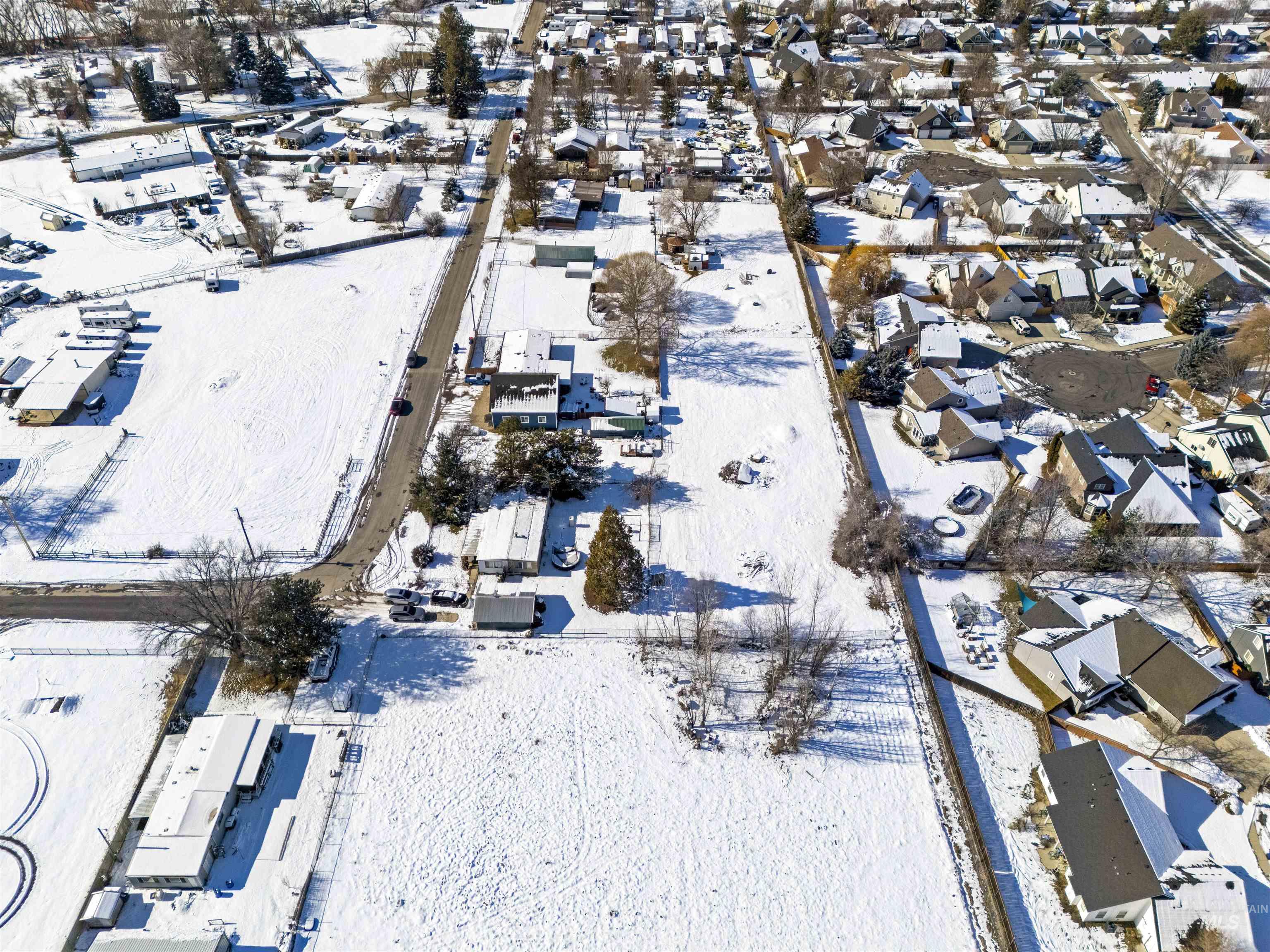 Snowy aerial view featuring a residential view