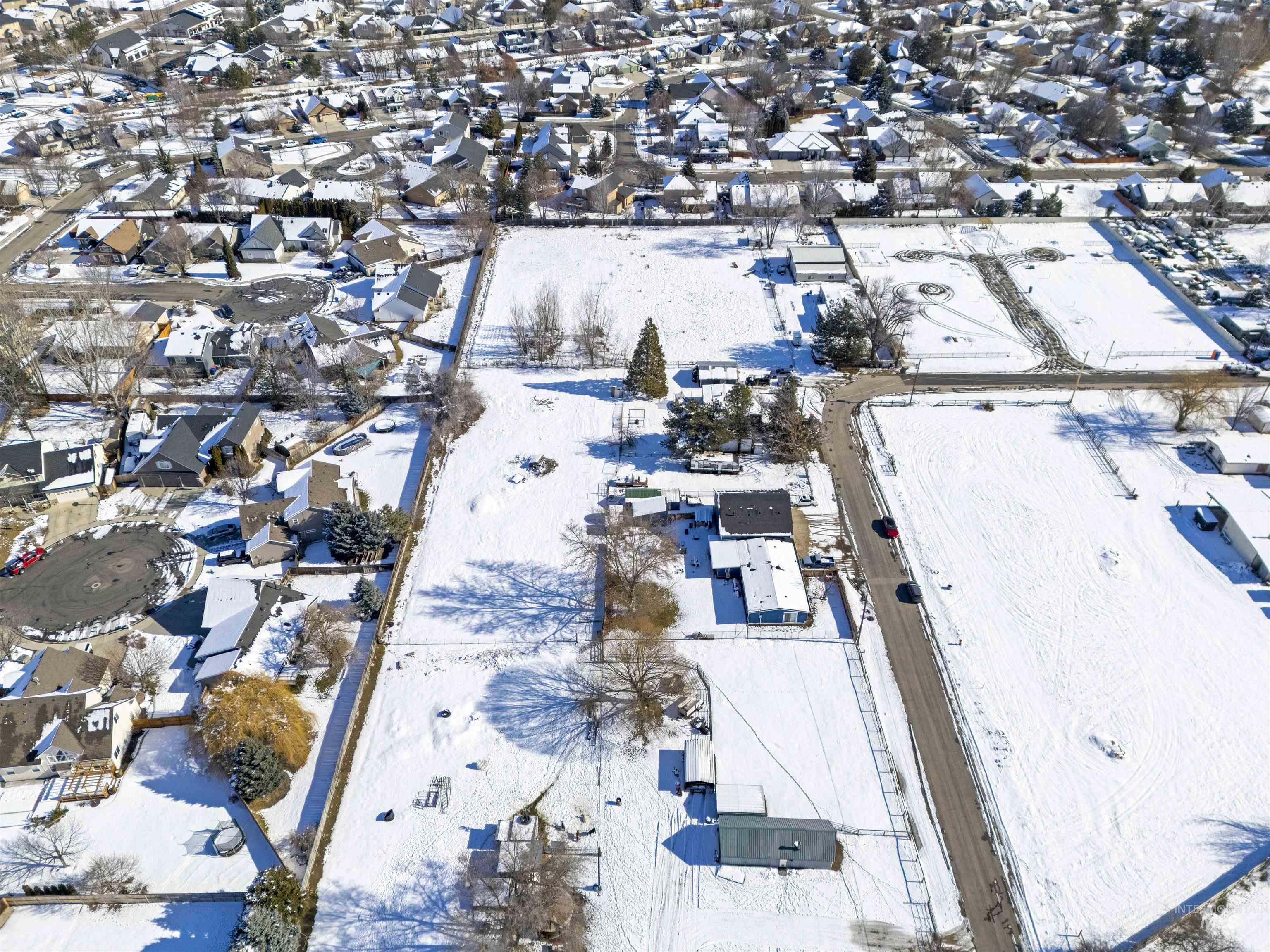 Snowy aerial view featuring a residential view
