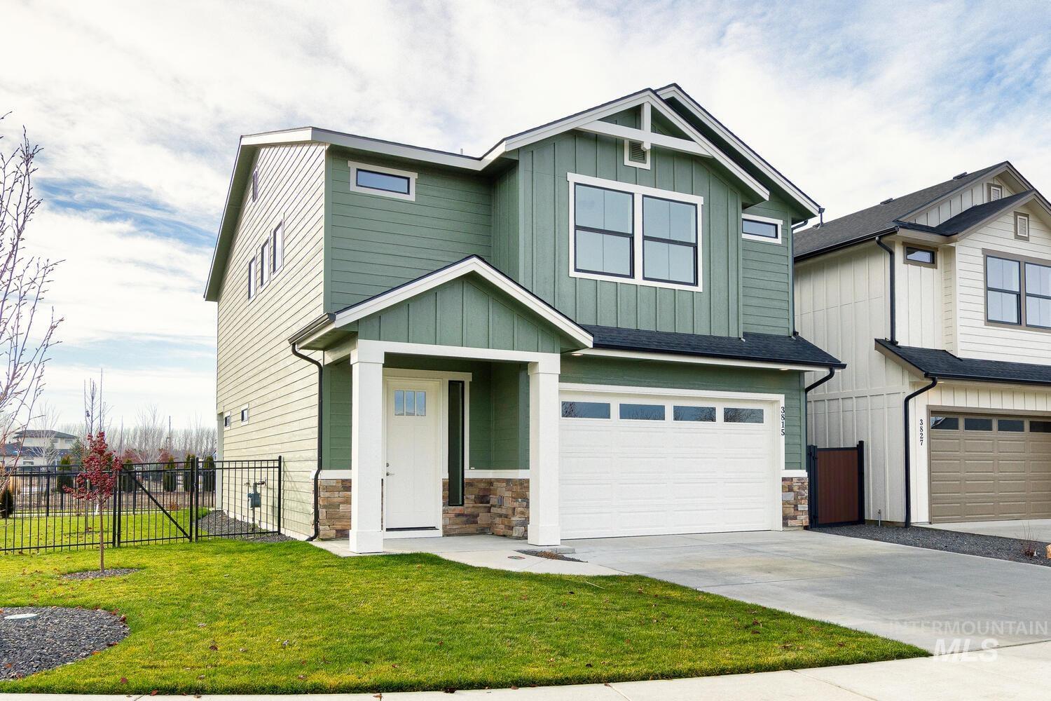 Craftsman-style home featuring a garage, board and batten siding, stone siding, and concrete driveway