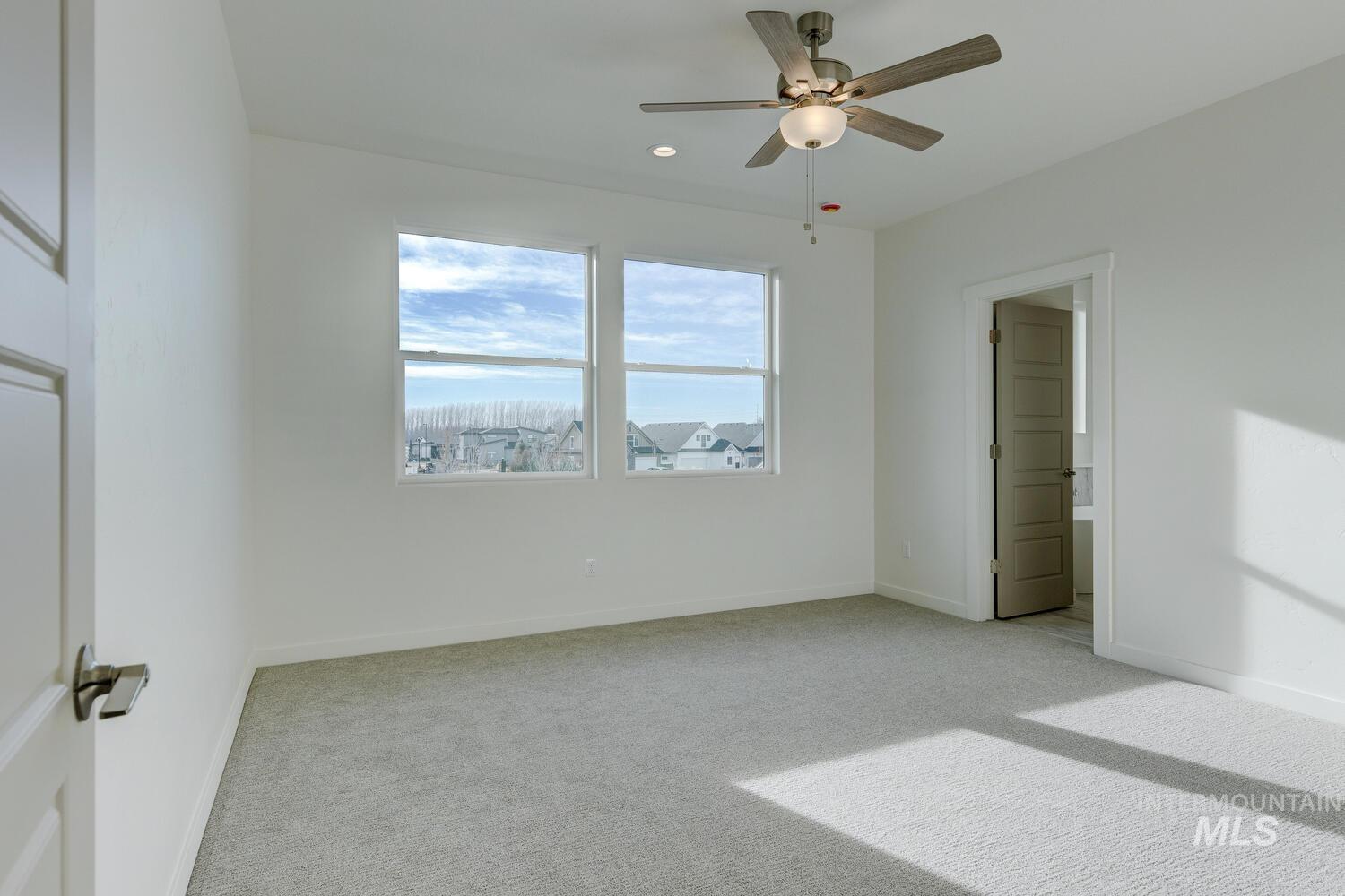 Unfurnished bedroom featuring light carpet, ceiling fan, and recessed lighting