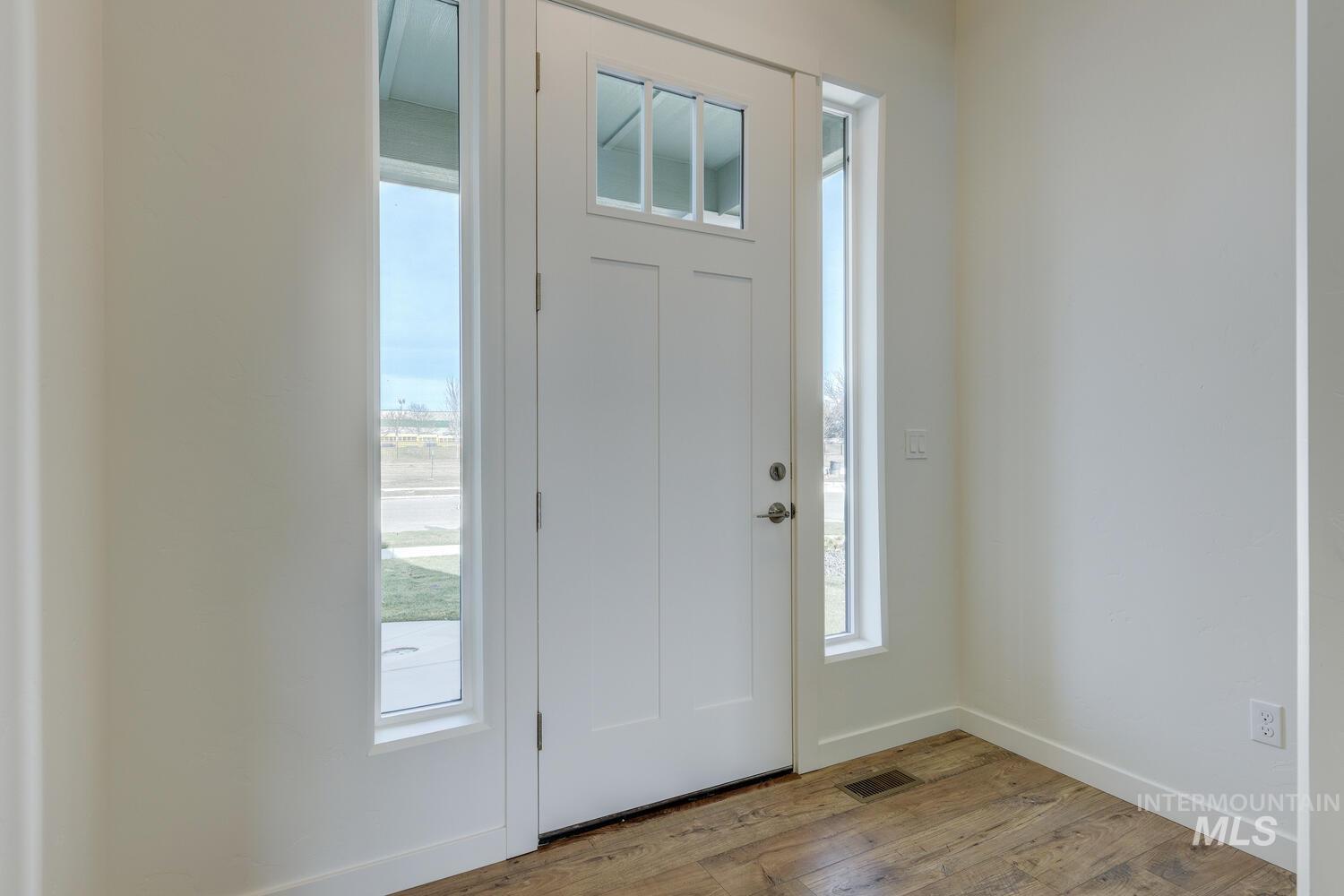 Entryway with wood finished floors and plenty of natural light