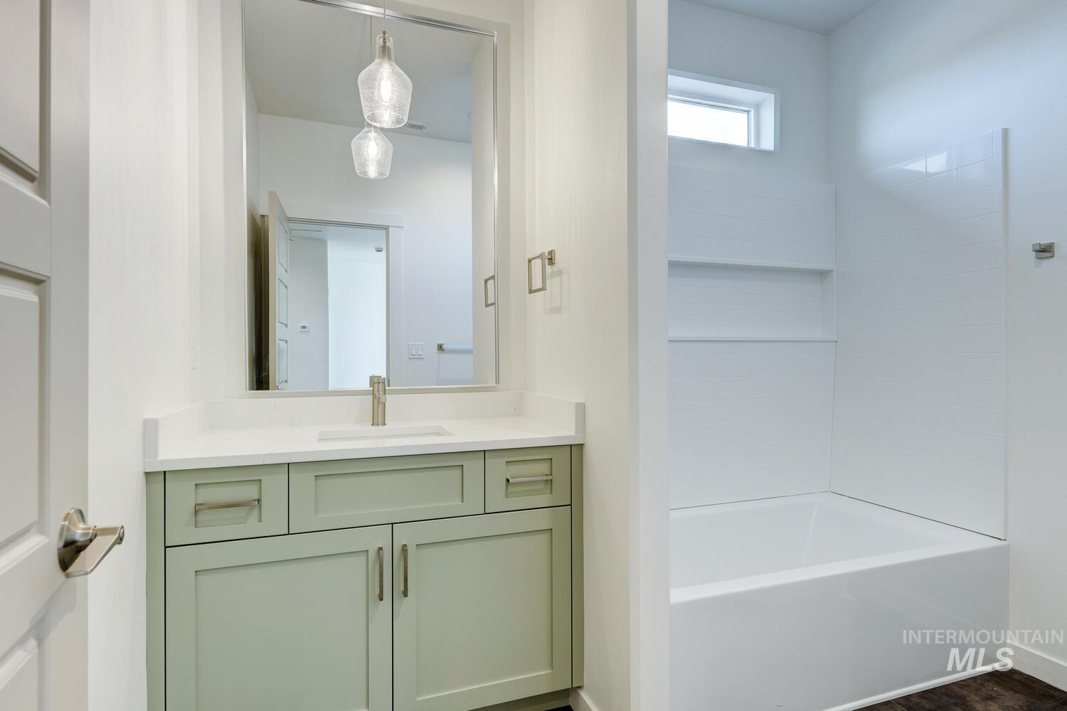 Full bath featuring vanity and shower / washtub combination