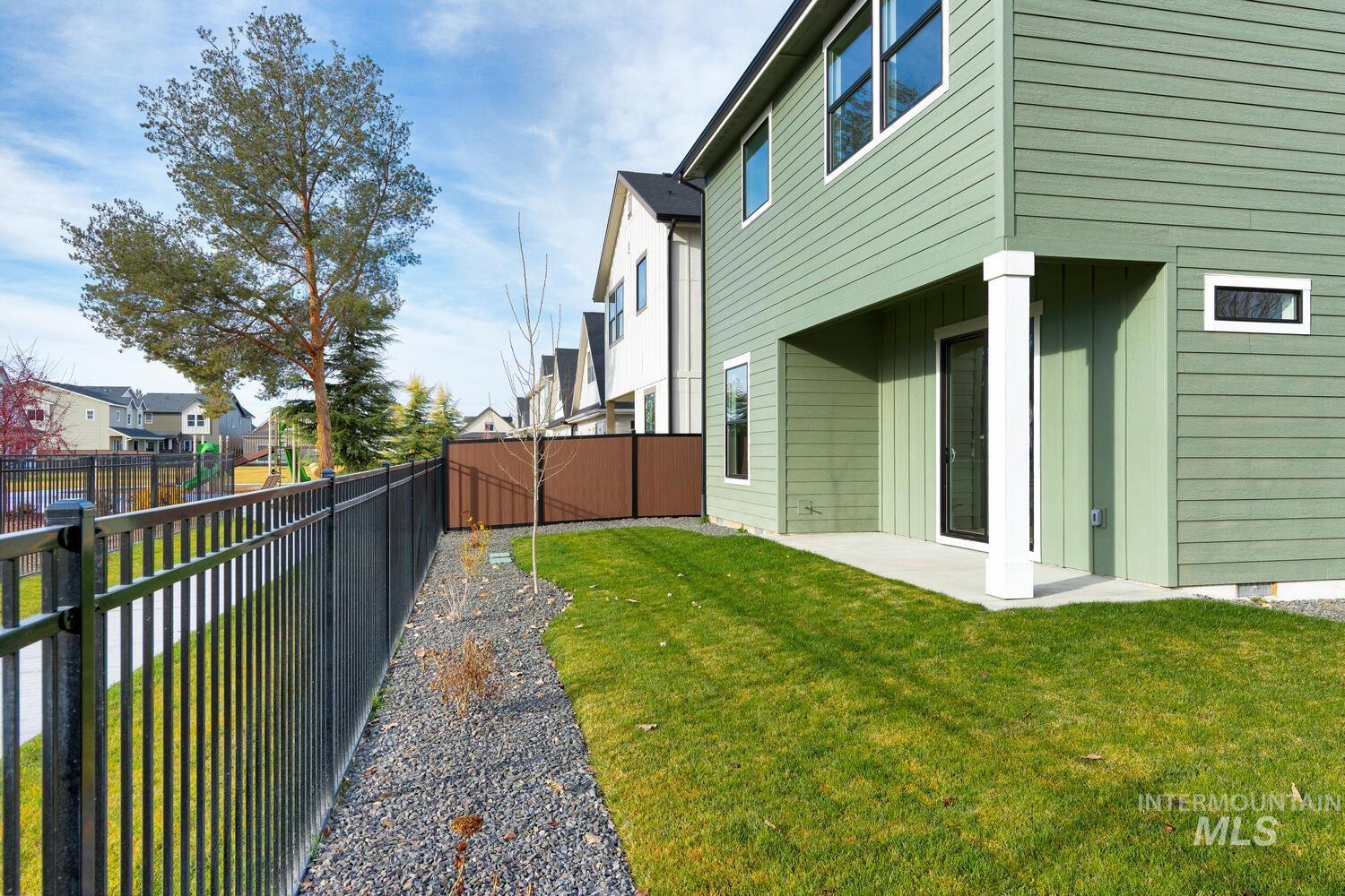 Fenced backyard with a residential view