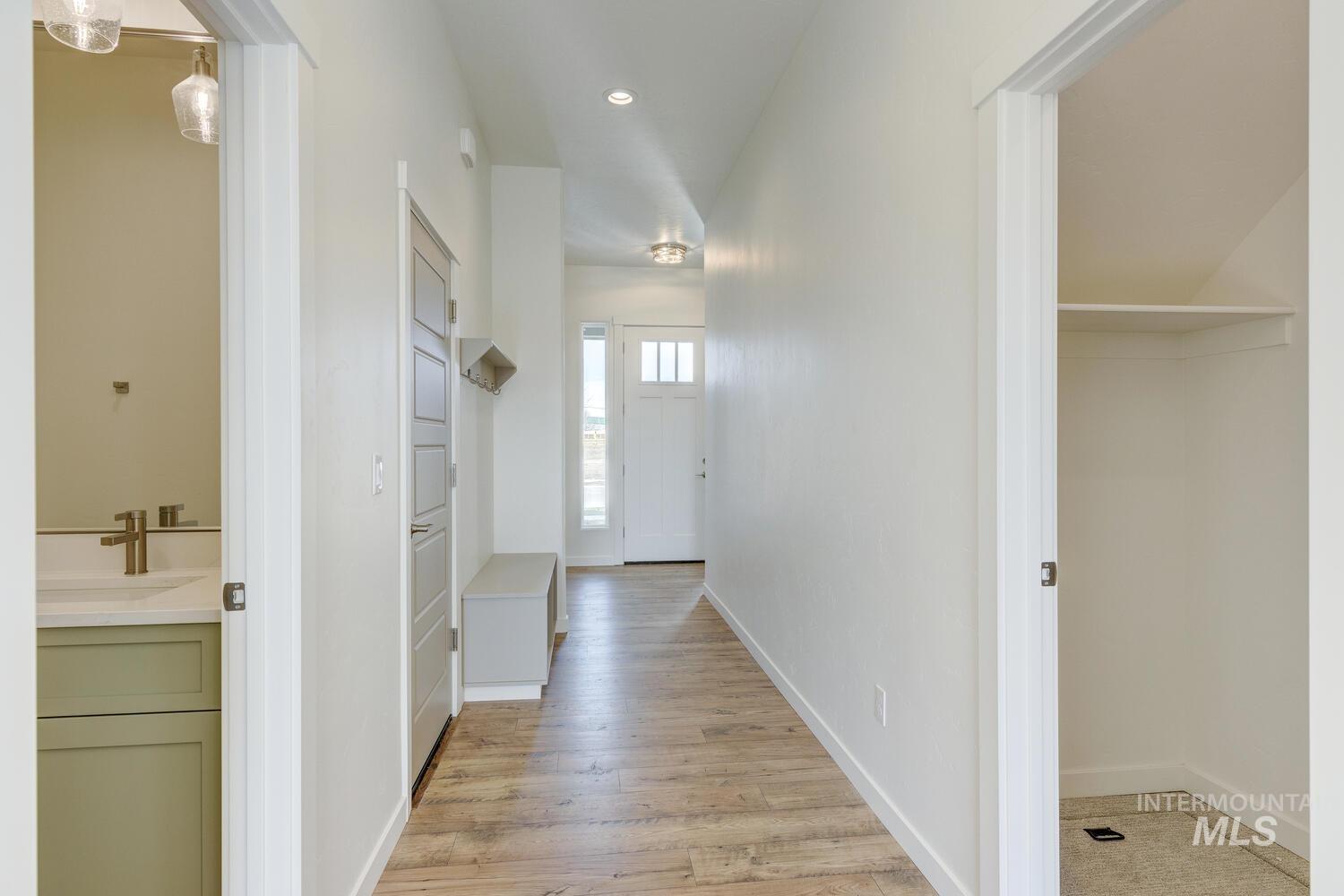 Corridor featuring light wood-style floors and recessed lighting