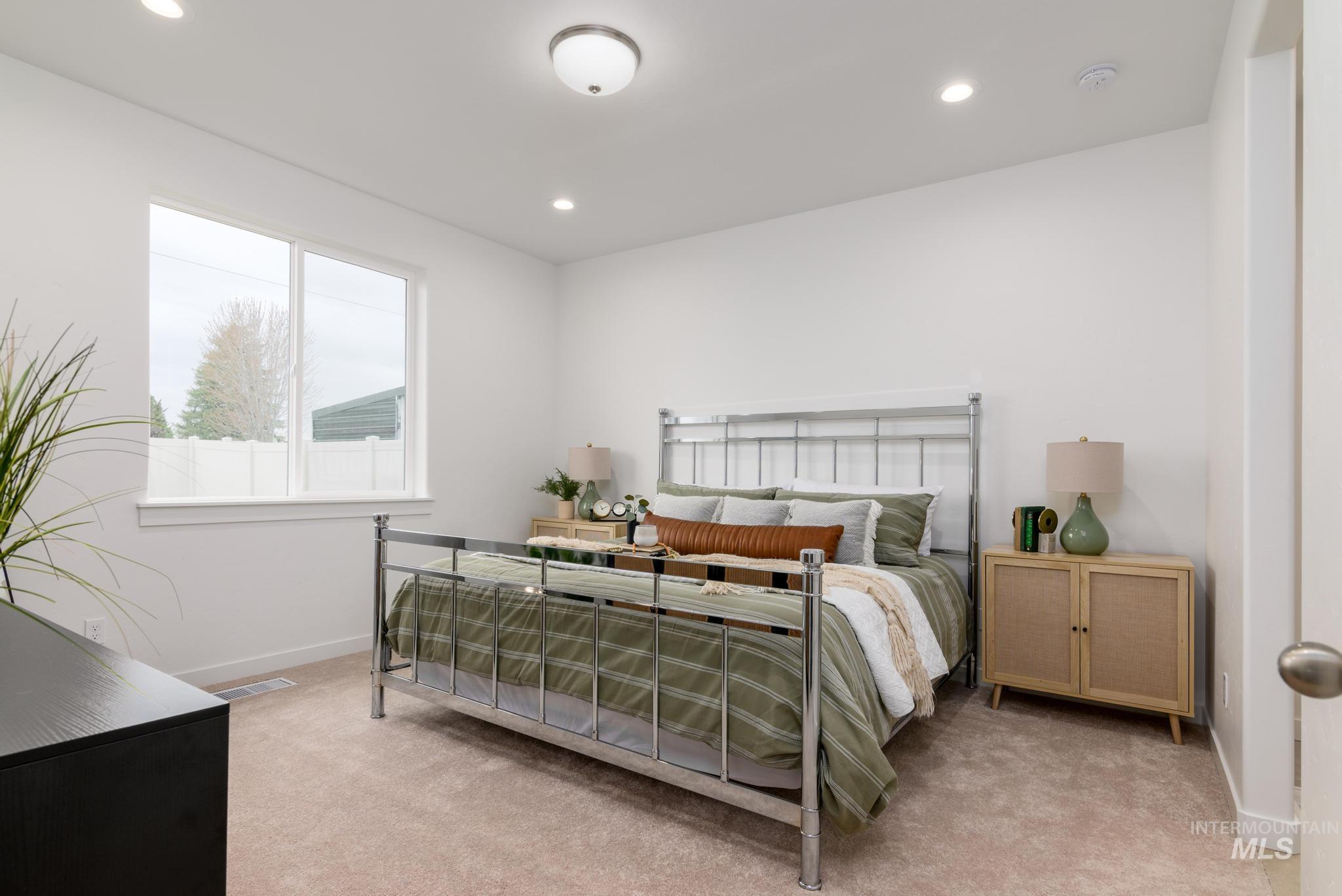 Bedroom featuring light colored carpet and recessed lighting