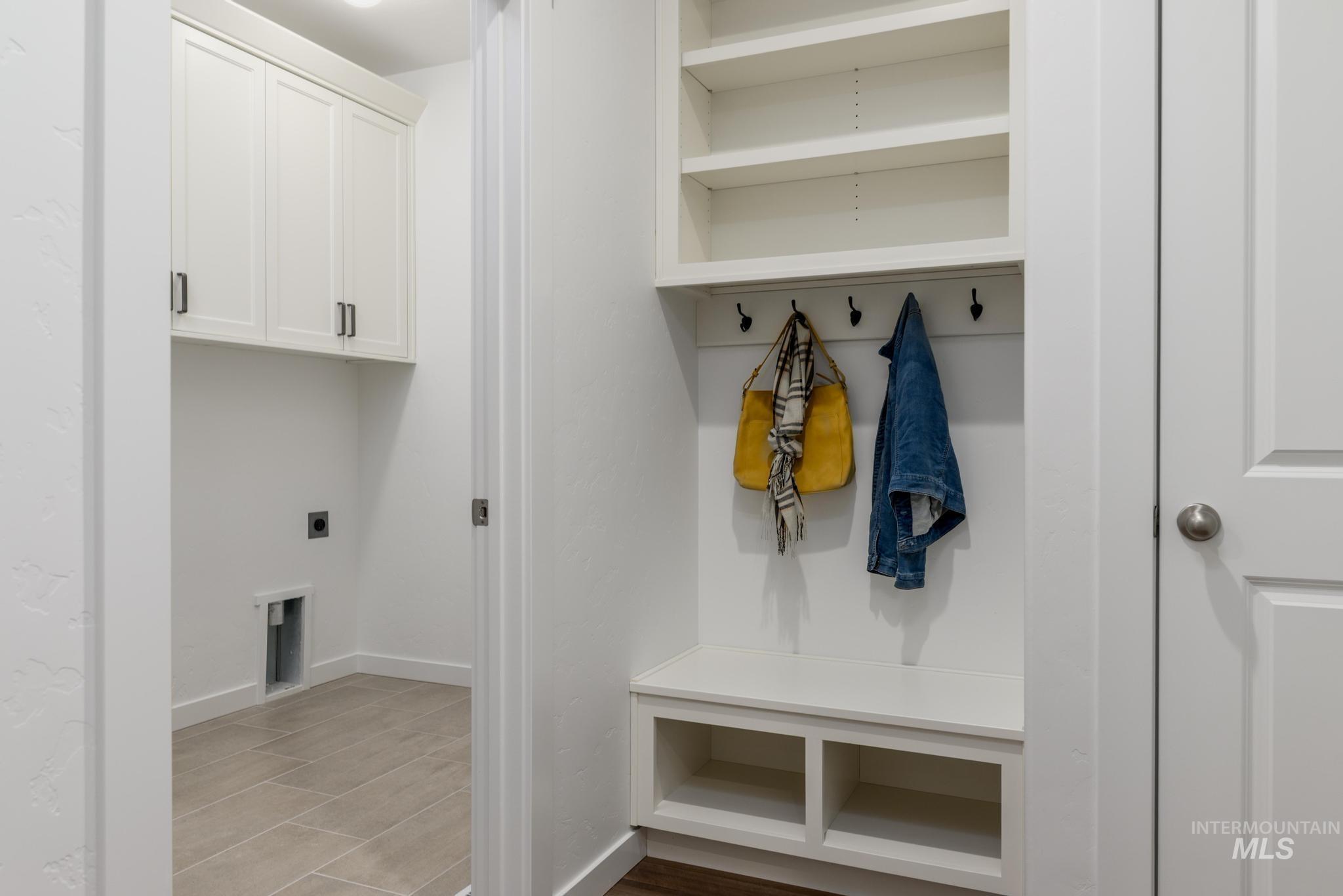 Mudroom with light wood-type flooring and baseboards