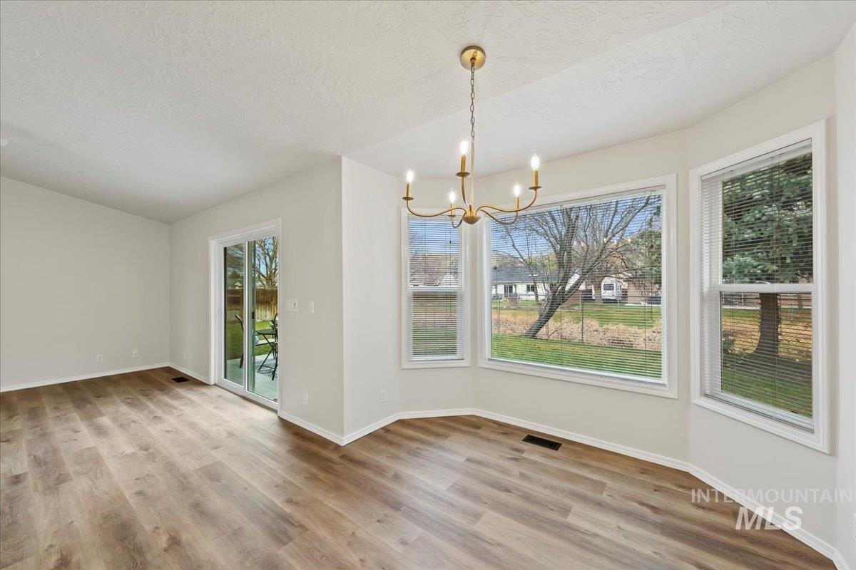 Adjoining Eating Space has NEW Chandelier, Bay Window looking out to backyard & Filtered Foothills View!