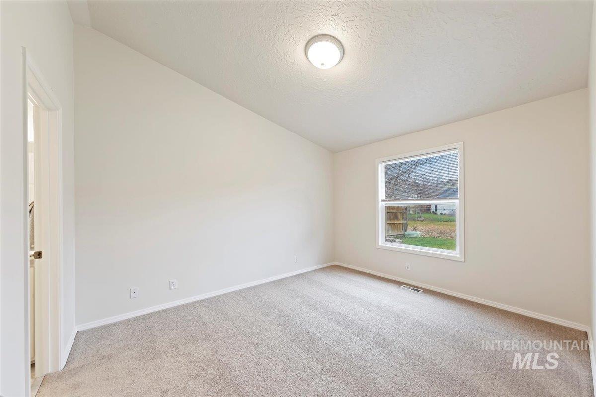 Master Bedroom Retreat at the Far back of the House!  Has a Lofted Ceiling, Window to Backyard, Brand New Carpet & Pad, Professionally Painted in Sept 2025!