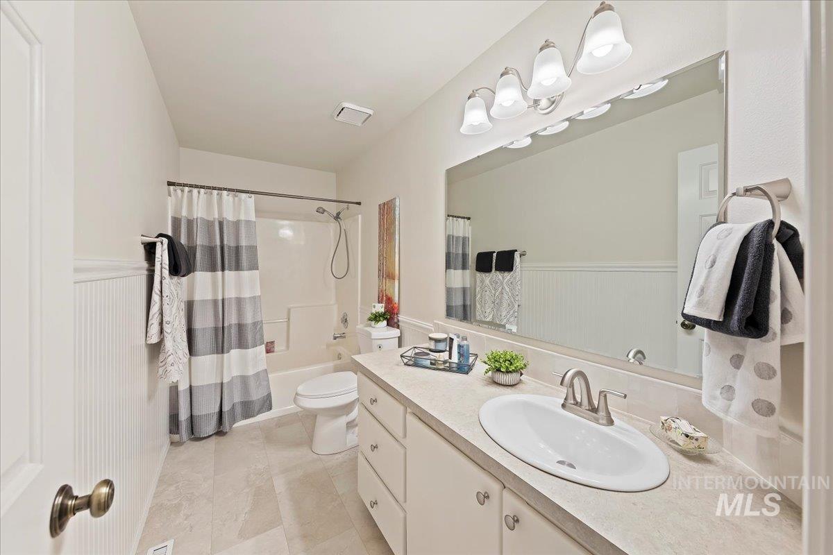 Main Bathroom has a Fiberglass Tub/Shower Combo, New Toilet, New Sink, Painted Cabinets, New Countertop w/Tiled Backsplash, Wainscoting wall Accent - BRAND NEW Luxury Vinyl Tile (LVT) Flooring!