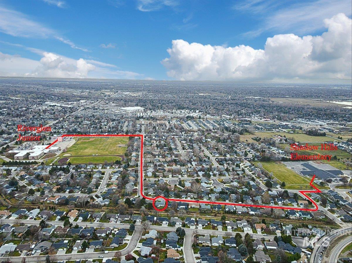 Aerial view of property and surrounding area with property boundaries highlighted and nearby suburban area