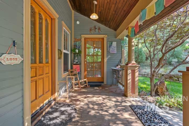 Doorway to property featuring a porch