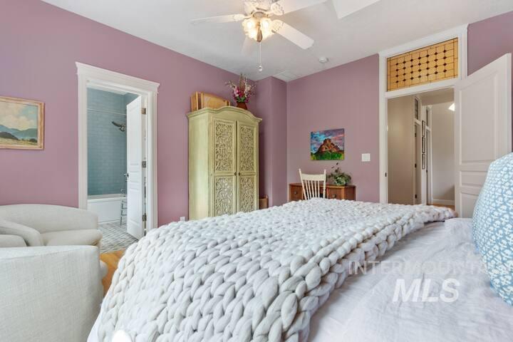 Bedroom featuring a ceiling fan and ensuite bath