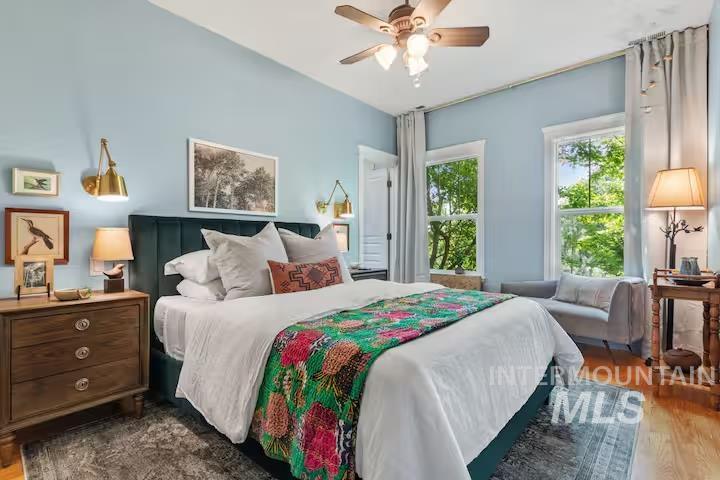 Bedroom with dark wood finished floors and ceiling fan