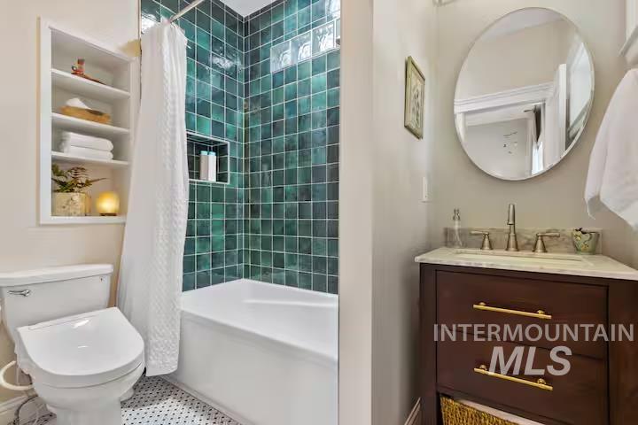 Full bath with vanity, shower / tub combo with curtain, and built in features