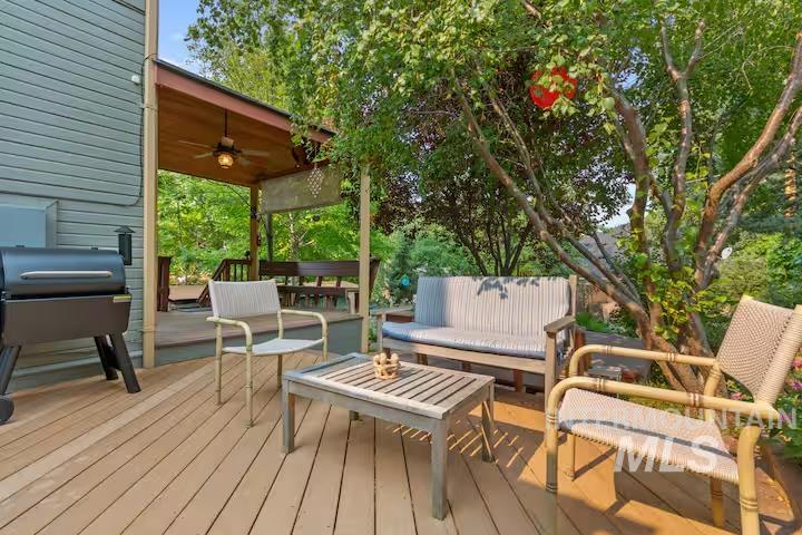 Deck featuring an outdoor hangout area, ceiling fan, and area for grilling