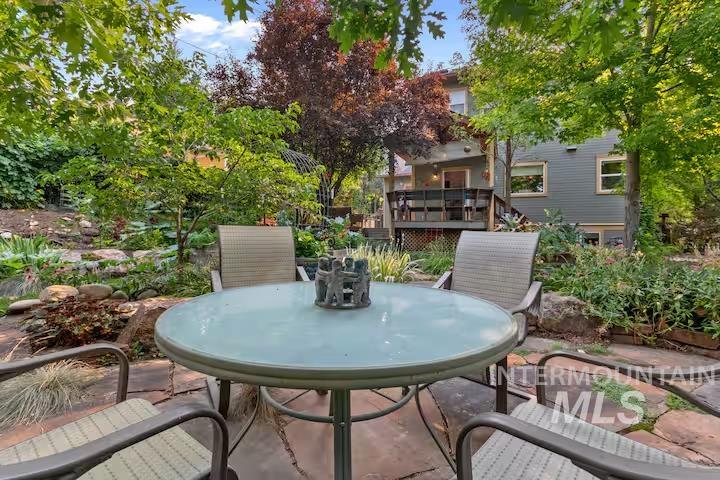 View of patio / terrace featuring outdoor dining space and a wooden deck