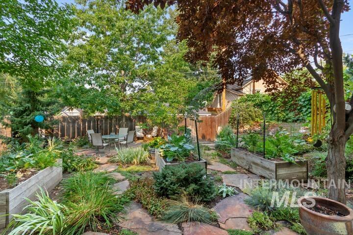 View of yard featuring a vegetable garden and a patio area