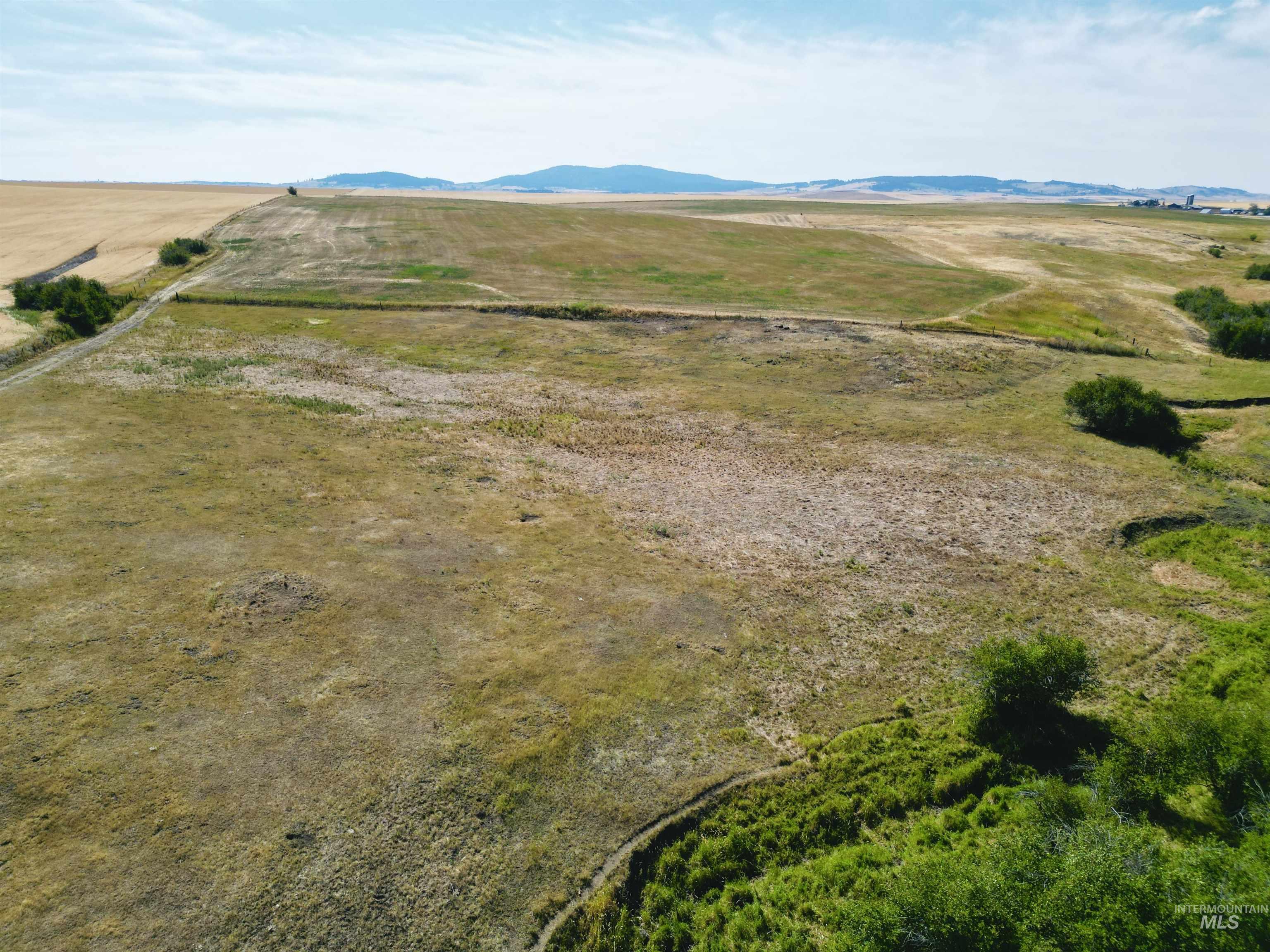 Aerial overview of property's location with rural landscape and mountains