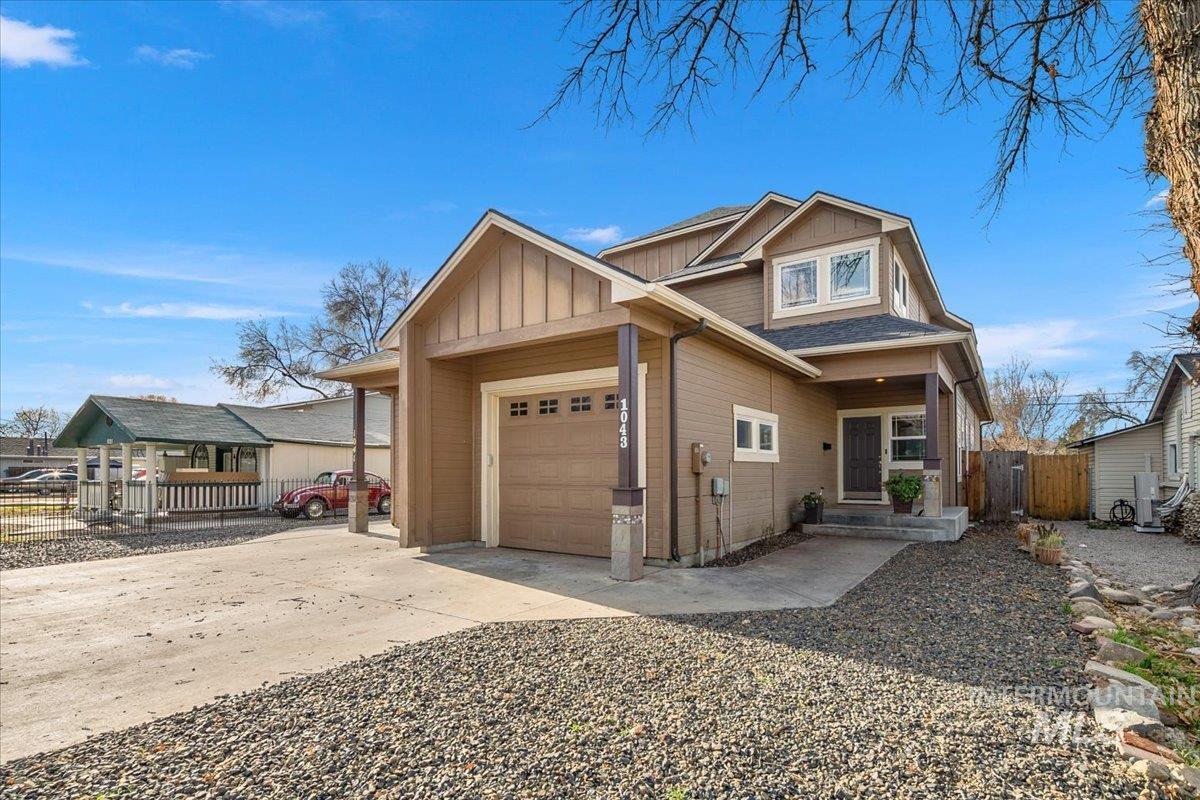 View of front facade featuring concrete driveway, board and batten siding, and an attached garage