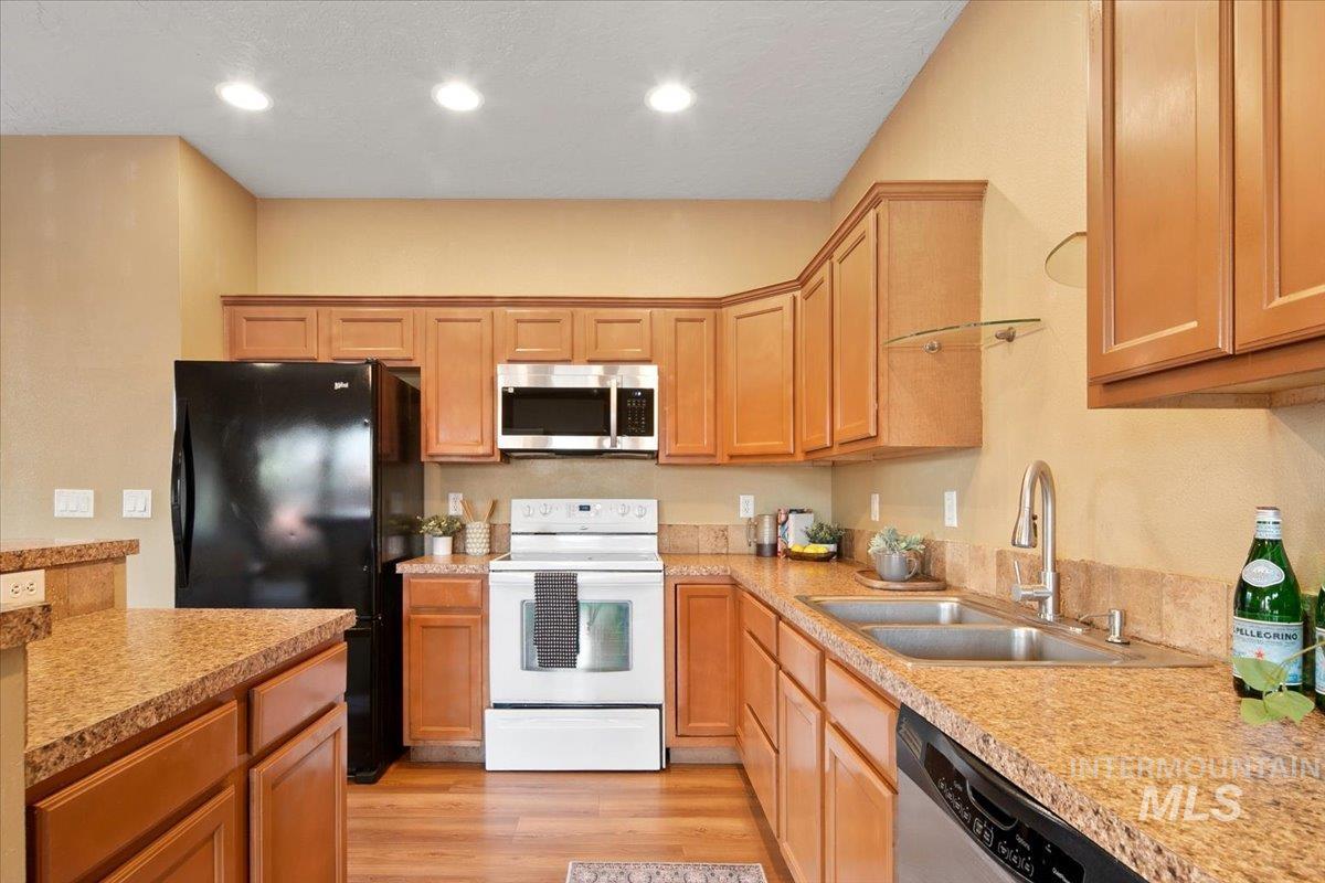 Kitchen with appliances with stainless steel finishes, light wood-style flooring, and recessed lighting