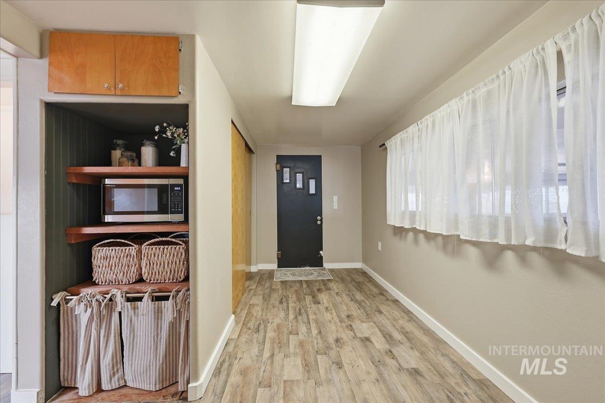 Entryway featuring wood finished floors and baseboards