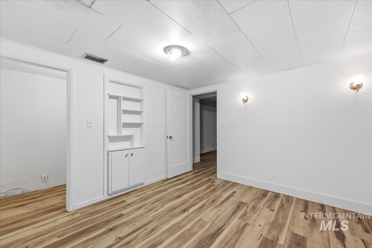 Empty room with light wood-style flooring and built in features