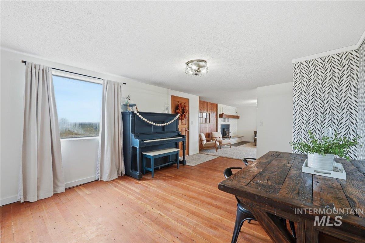 Dining room featuring a textured ceiling and light wood-type flooring