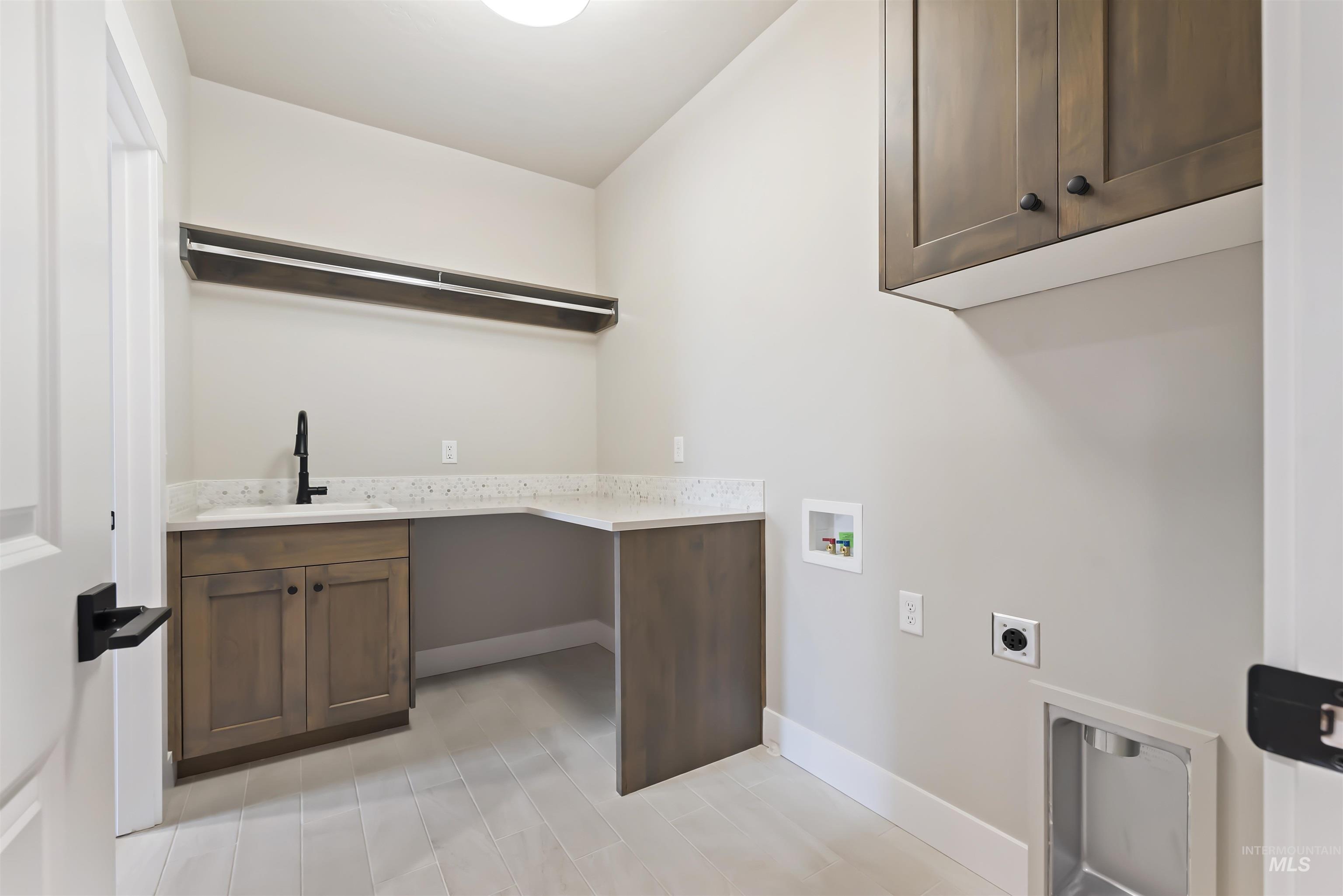 Washroom with washer hookup, cabinet space, and electric dryer hookup
