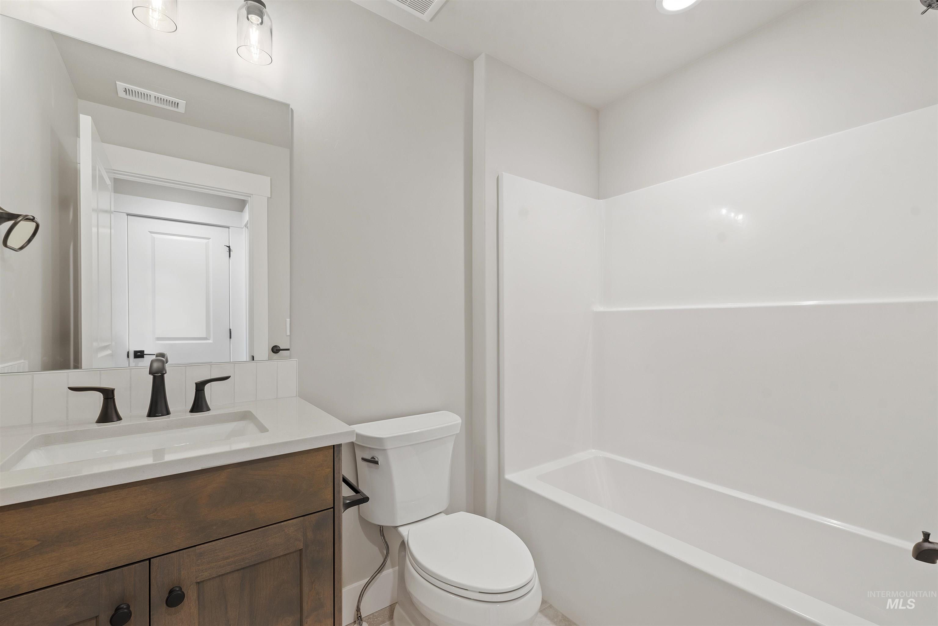 Full bathroom with vanity and shower / tub combination